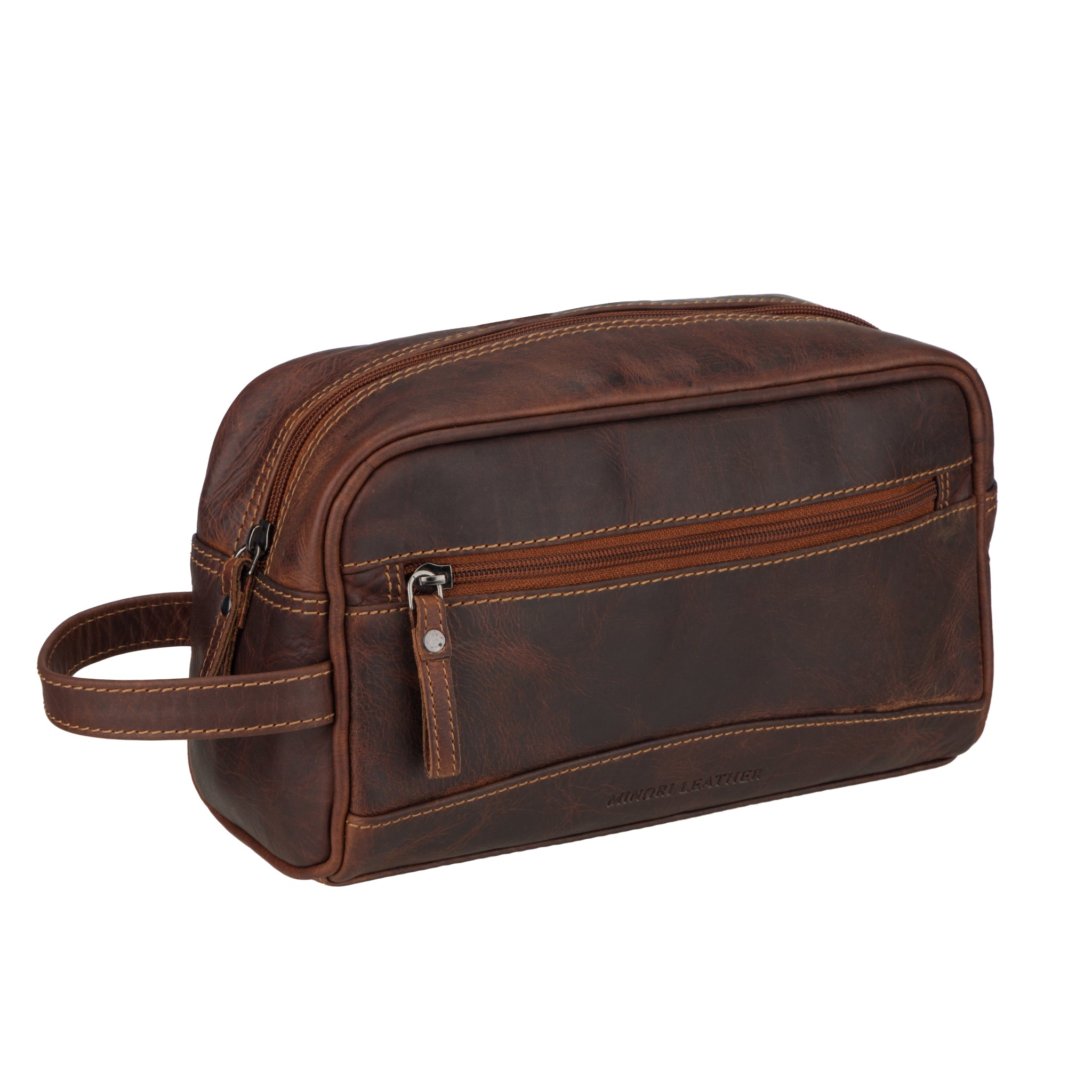 Angled view of Brown Minori leather toiletry bag on a white background