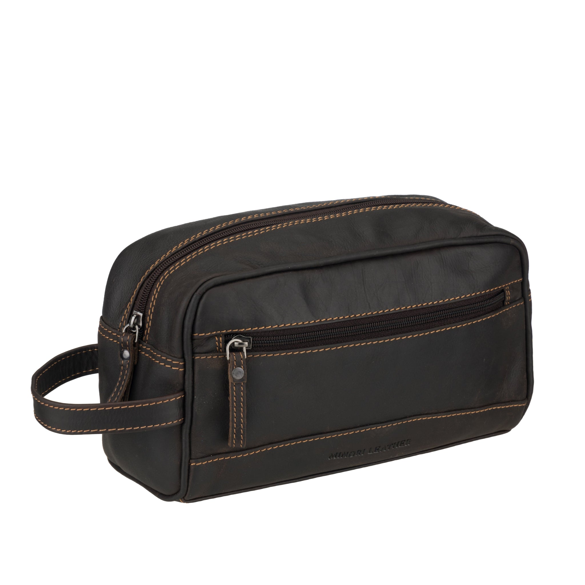 Angled view of Brown Minori leather toiletry bag with brown stitching on a white background