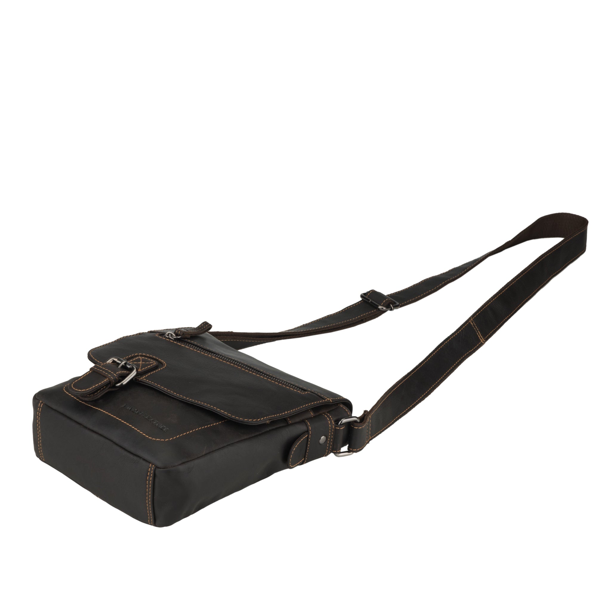 Side laying view of a brown Minori leather crossbody bag with flap slightly open.
