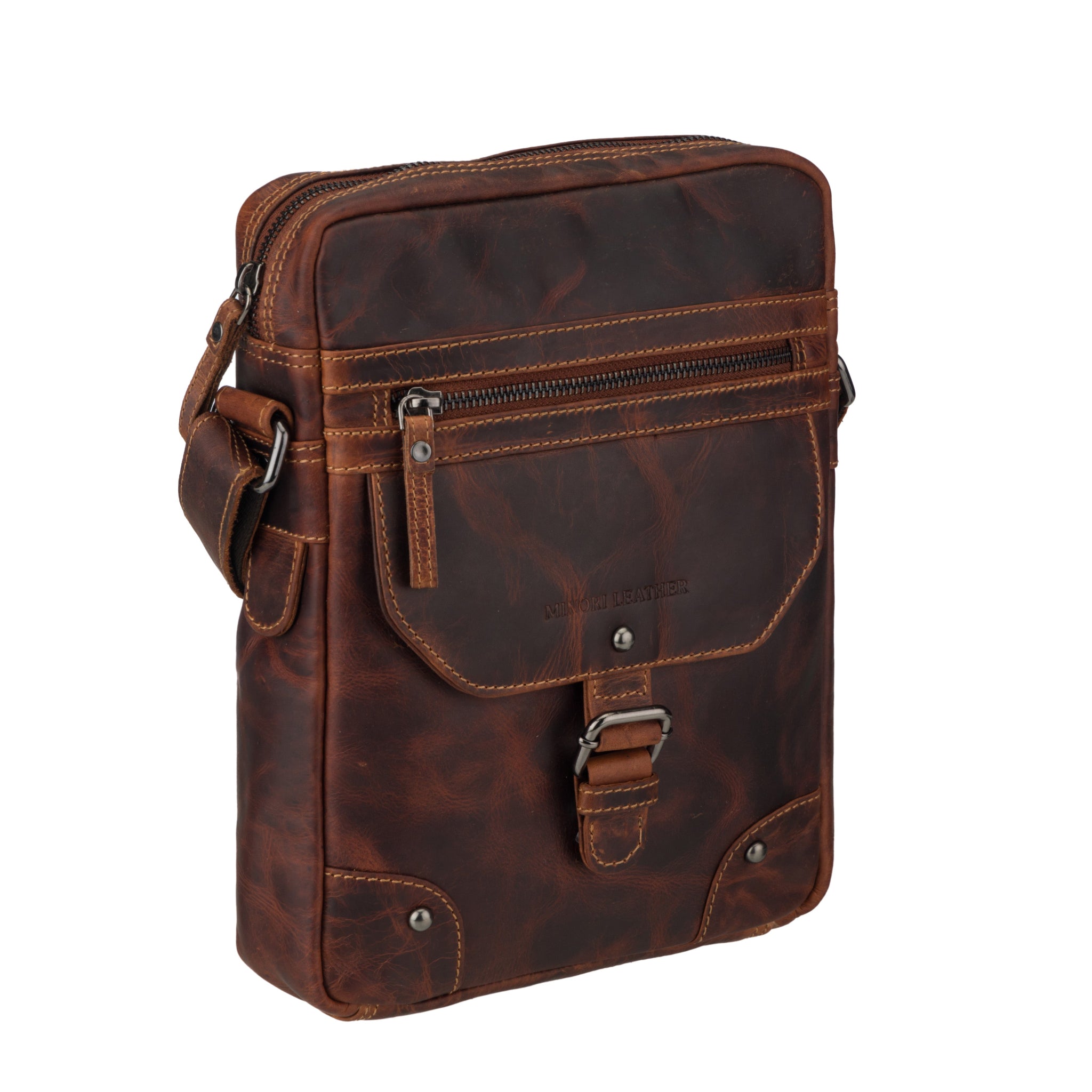 Angled front-side view of a distressed brown Minori leather shoulder bag with front zipper and flap pocket.