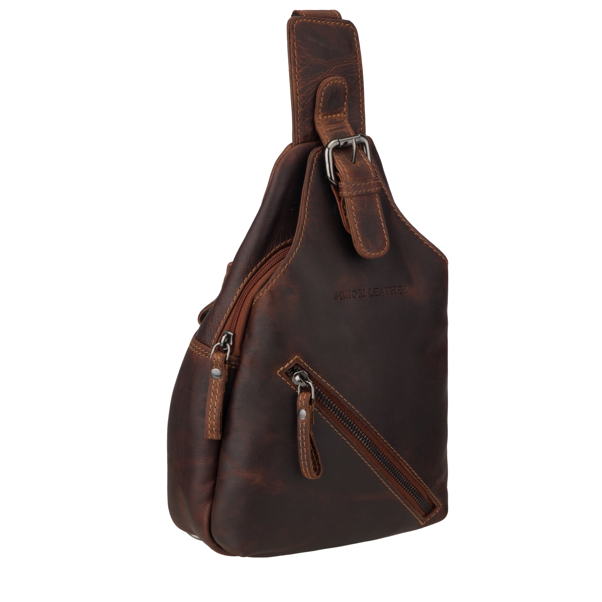 Side angled view of a chestnut brown Minori leather sling bag showing zippered pockets.