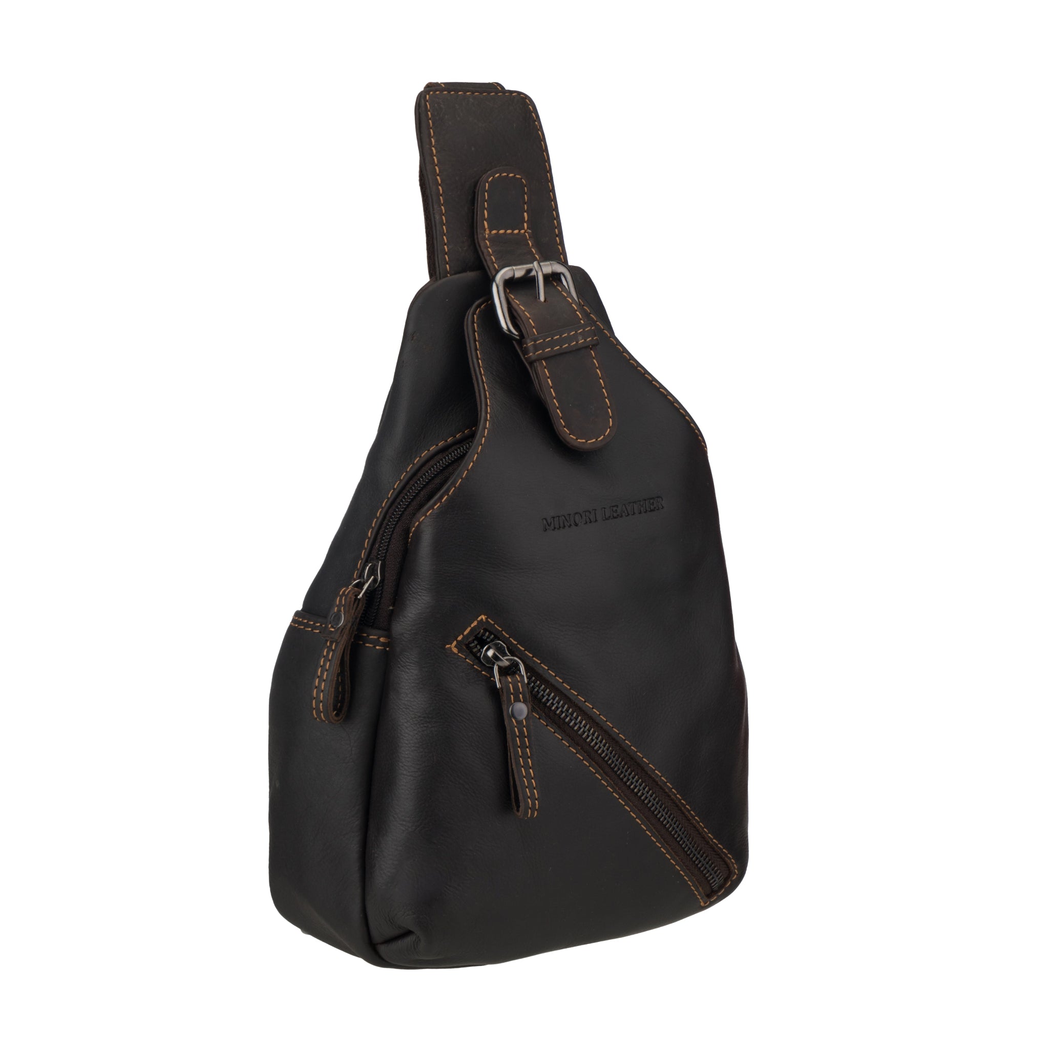 Angled side view of a brown Minori leather sling bag highlighting its curved shape and front zipper.