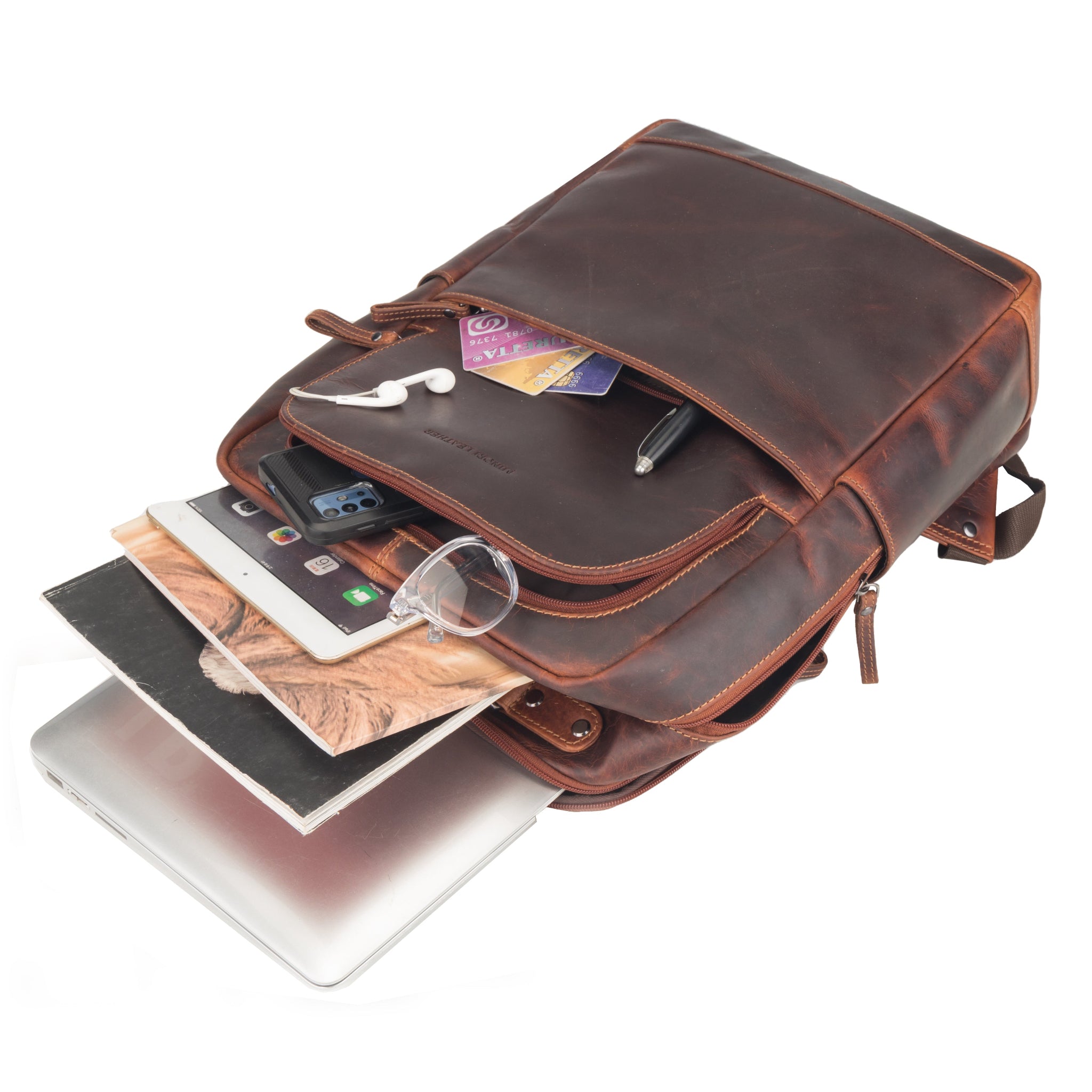 Chestnut brown Minori leather backpack filled with tablet, books, and accessories, showing its organized storage space.