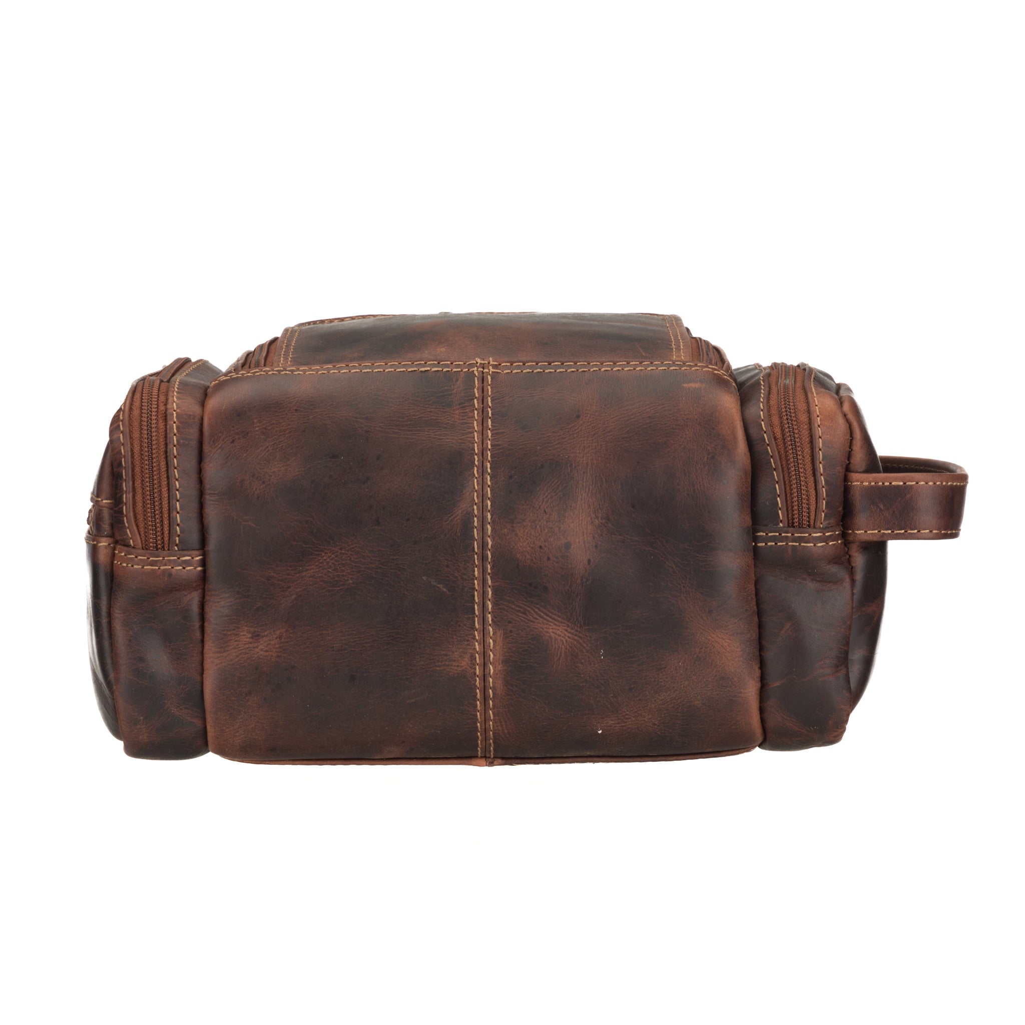 Chestnut brown Minori leather toiletry bag filled with grooming essentials such as bottles, trimmer, and travel toiletries, showing organized interior capacity.
