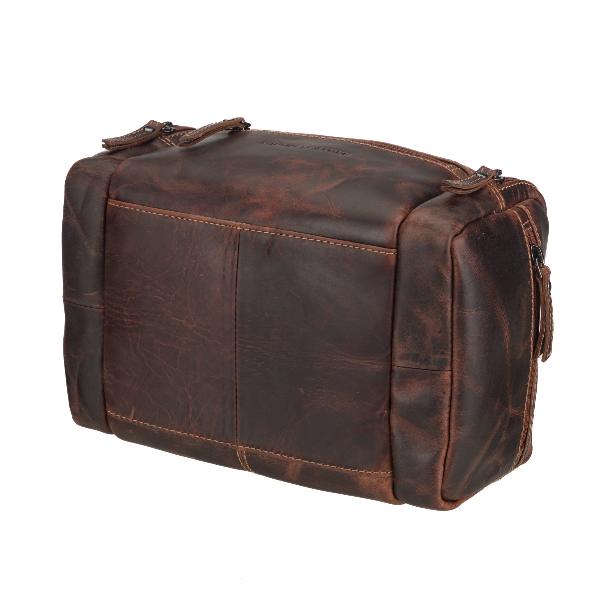 Angled rear view of chestnut brown Minori leather toiletry bag showing its boxy build and durable construction.