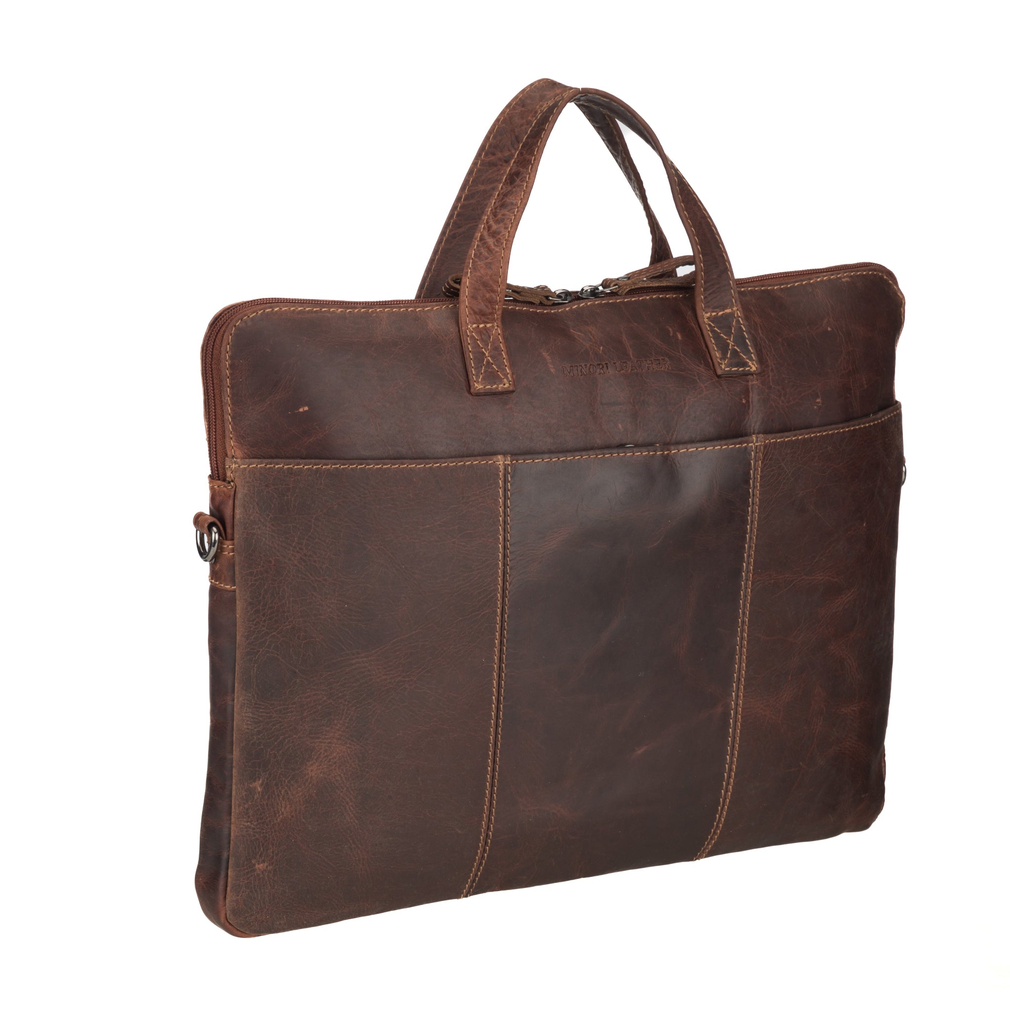 Side-angled shot of a slim Minori leather laptop bag lying flat, highlighting its compact and structured design.