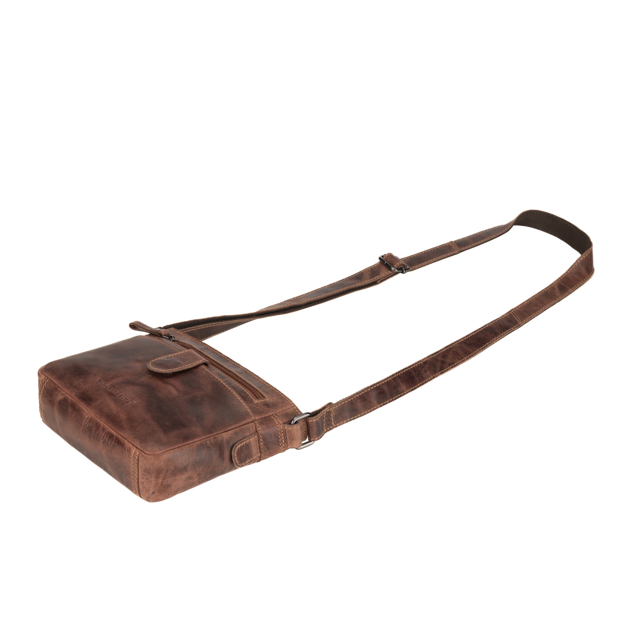 Flat lay view of Brown Minori leather bag with a strap on a white background