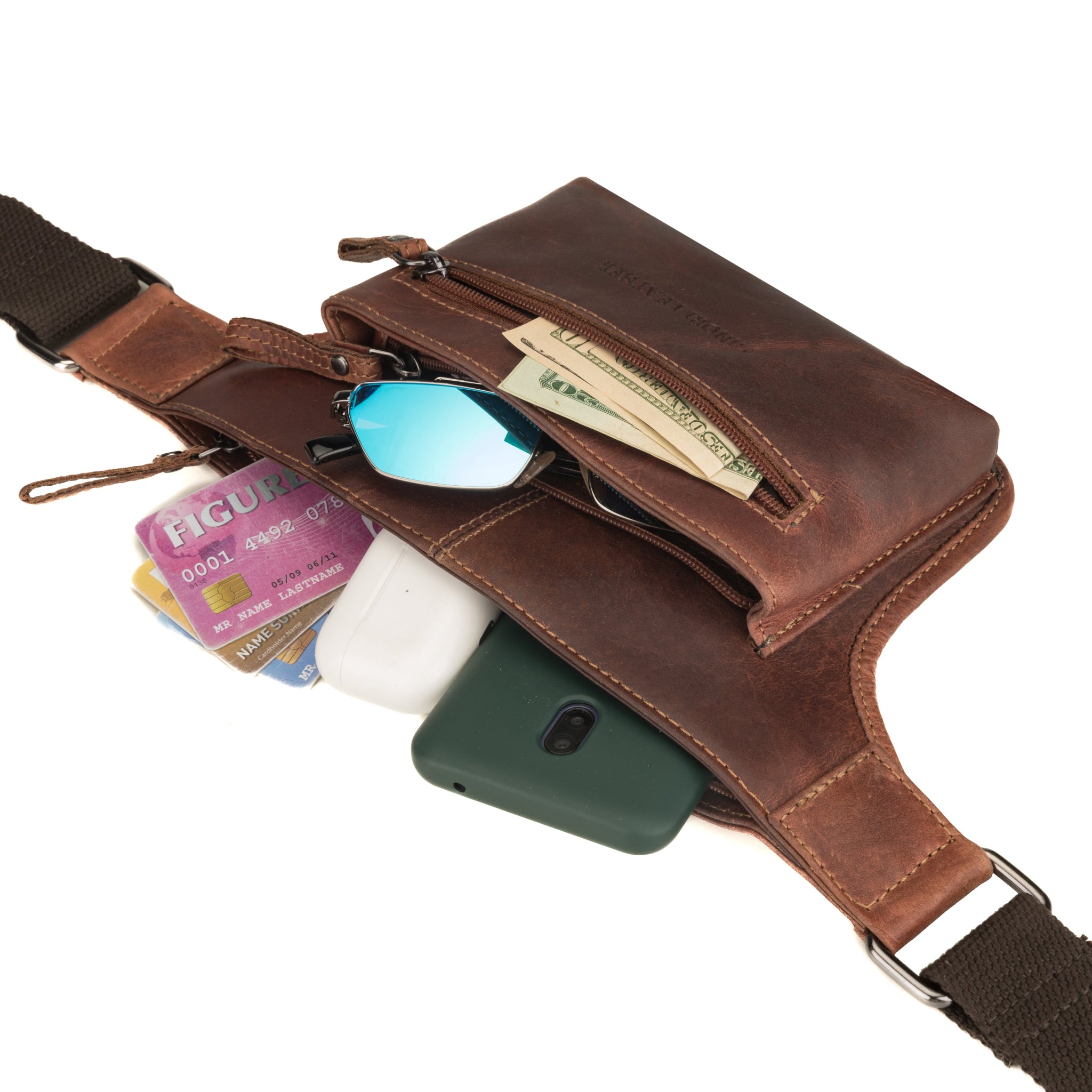 Minori Leather chestnut brown waist bag shown with contents including phone, cards, cash, and sunglasses partially visible.