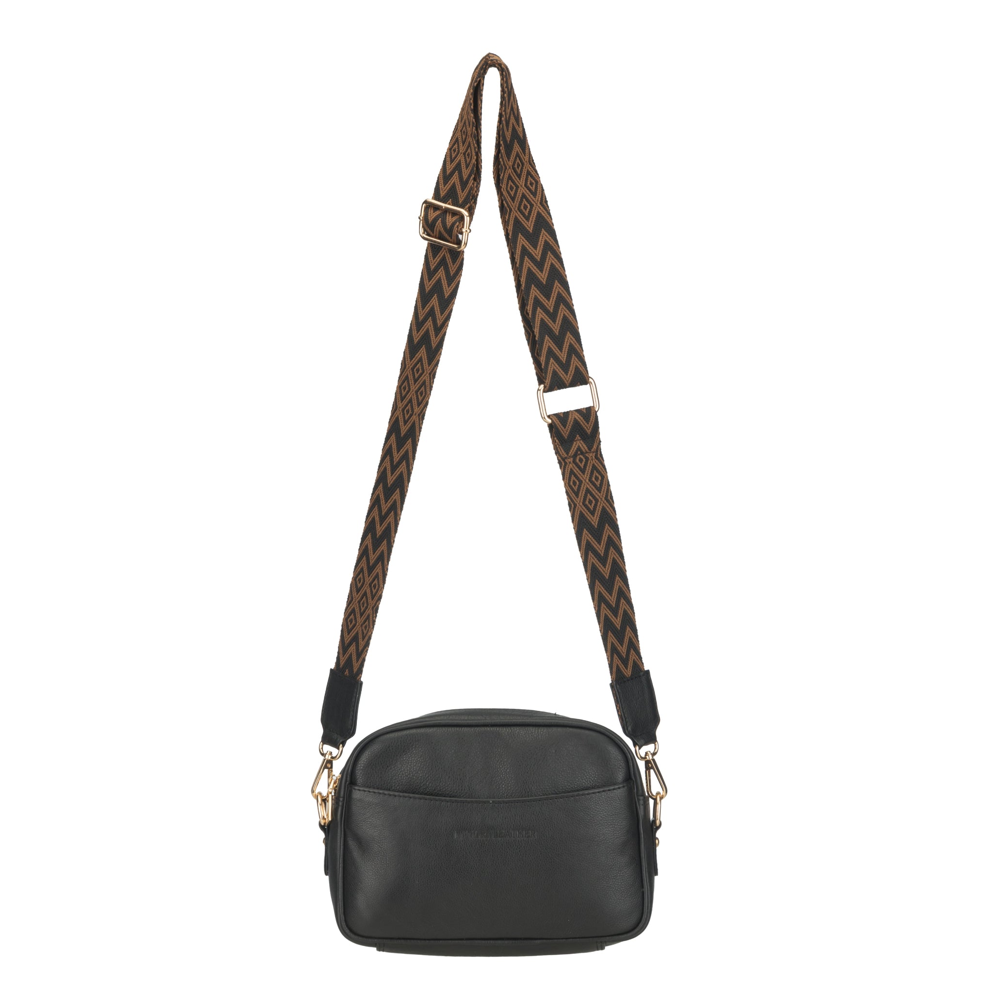 Black Minori leather crossbody bag with a wide brown zigzag-patterned strap displayed in a hanging position.