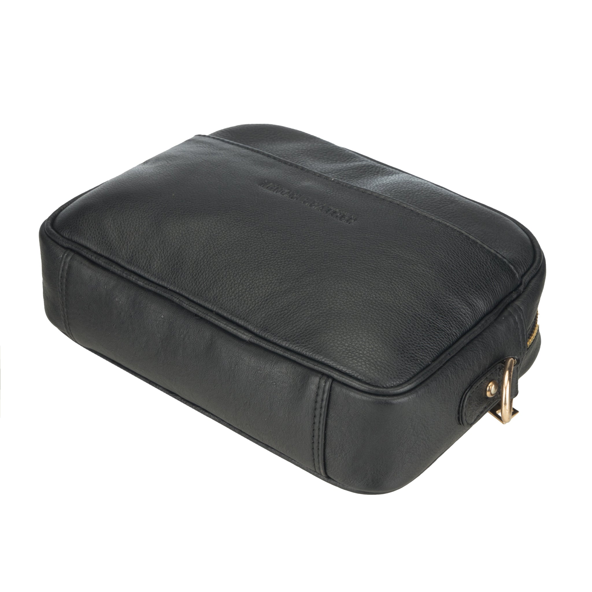 Bottom-side view of a black Minori leather crossbody bag showcasing its rectangular structure and metal D-ring.