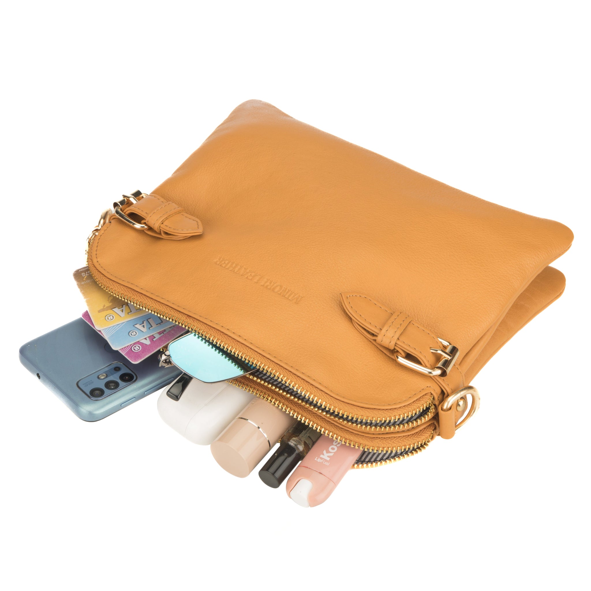 Minori tan leather handbag with contents spilling out, including phone, cards, and cosmetic items.