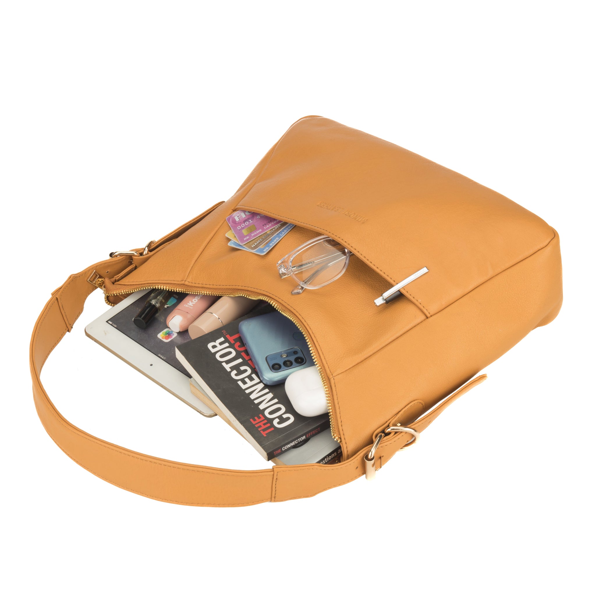 Mustard yellow Minori leather handbag with contents partially exposed, including a book, phone, makeup items, and cards.