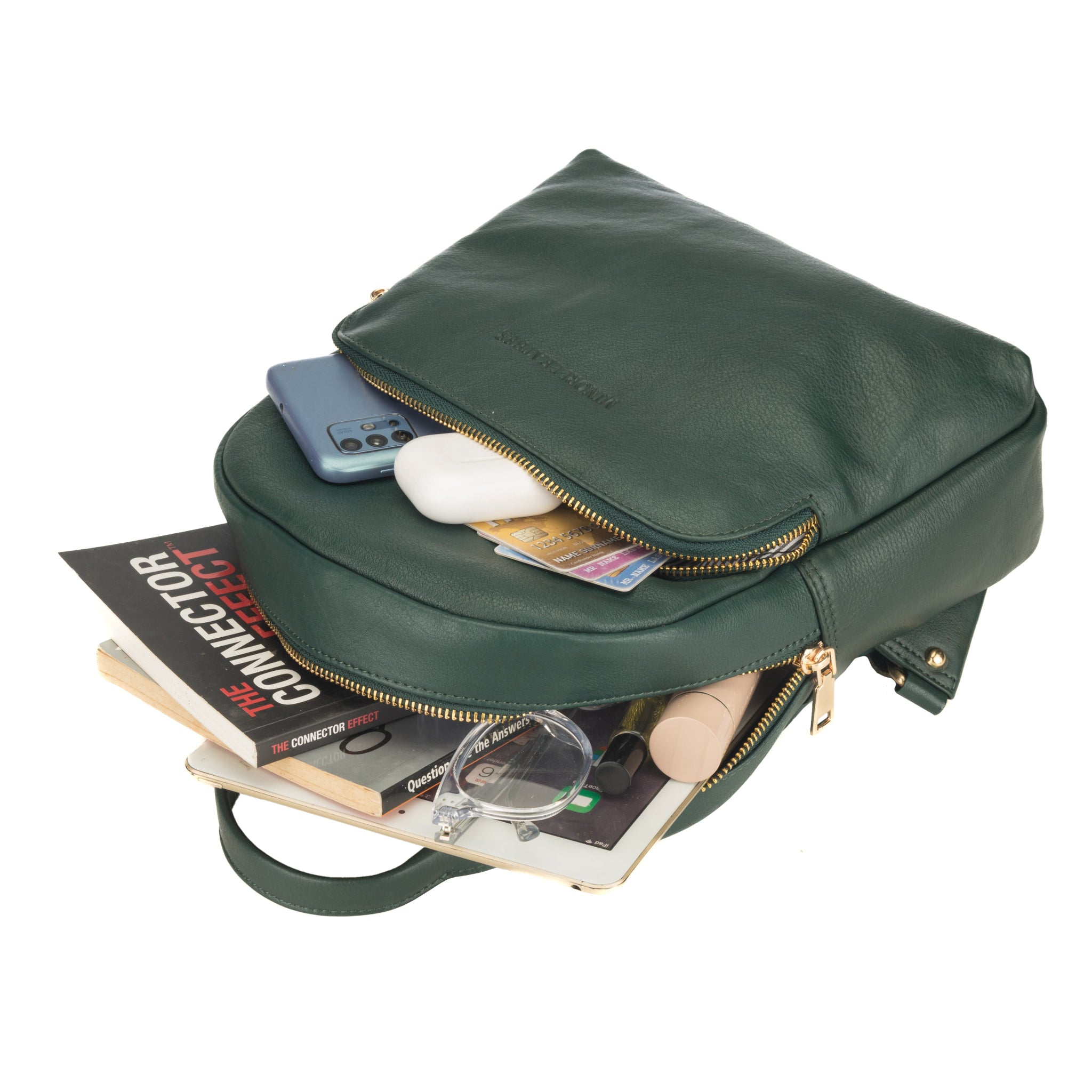 Forest Green Minori leather backpack with items spilling out on a white background