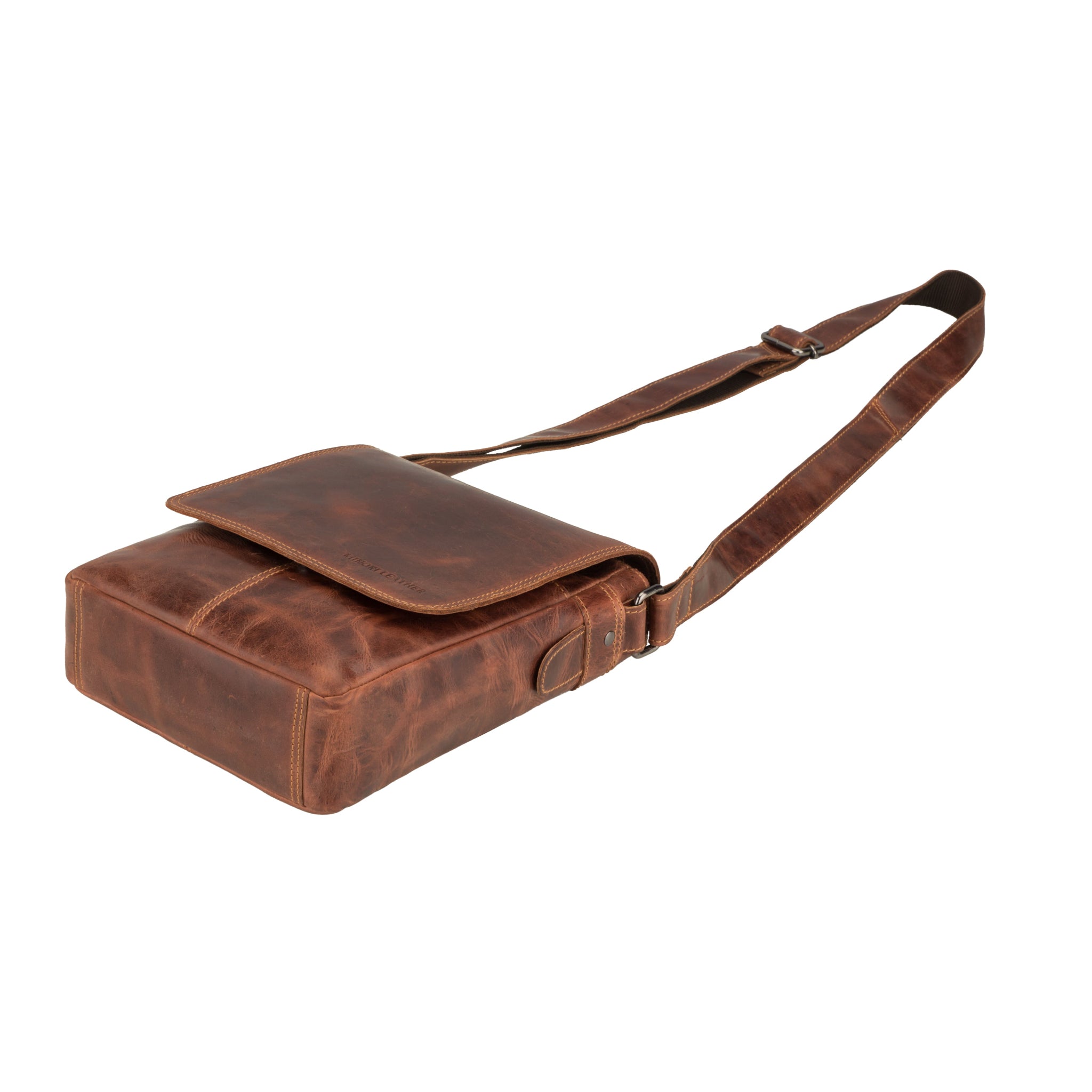 Flat lay view of Brown Minori leather bag with a strap on a white background