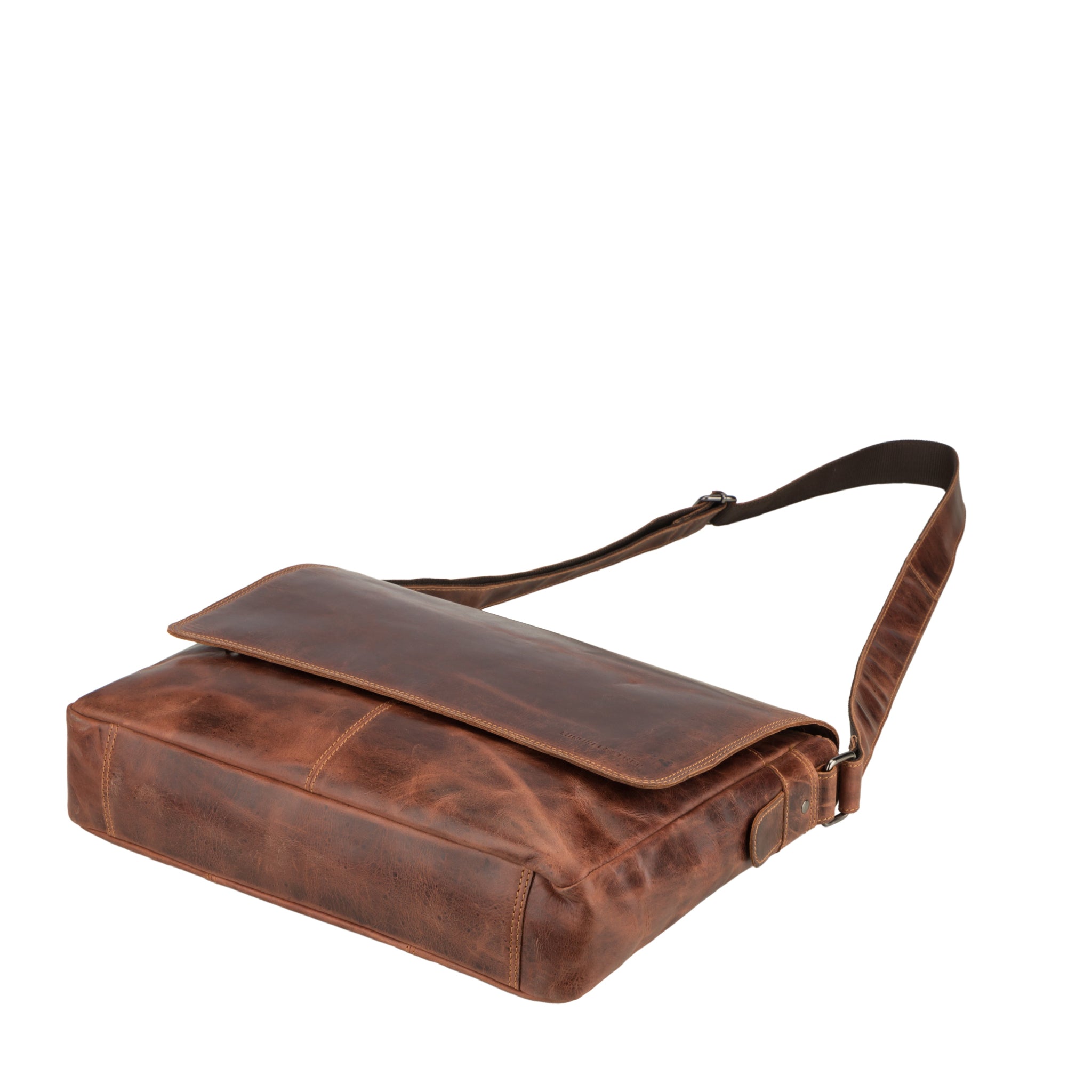 Flat lay view of Brown Minori leather bag with a strap on a white background