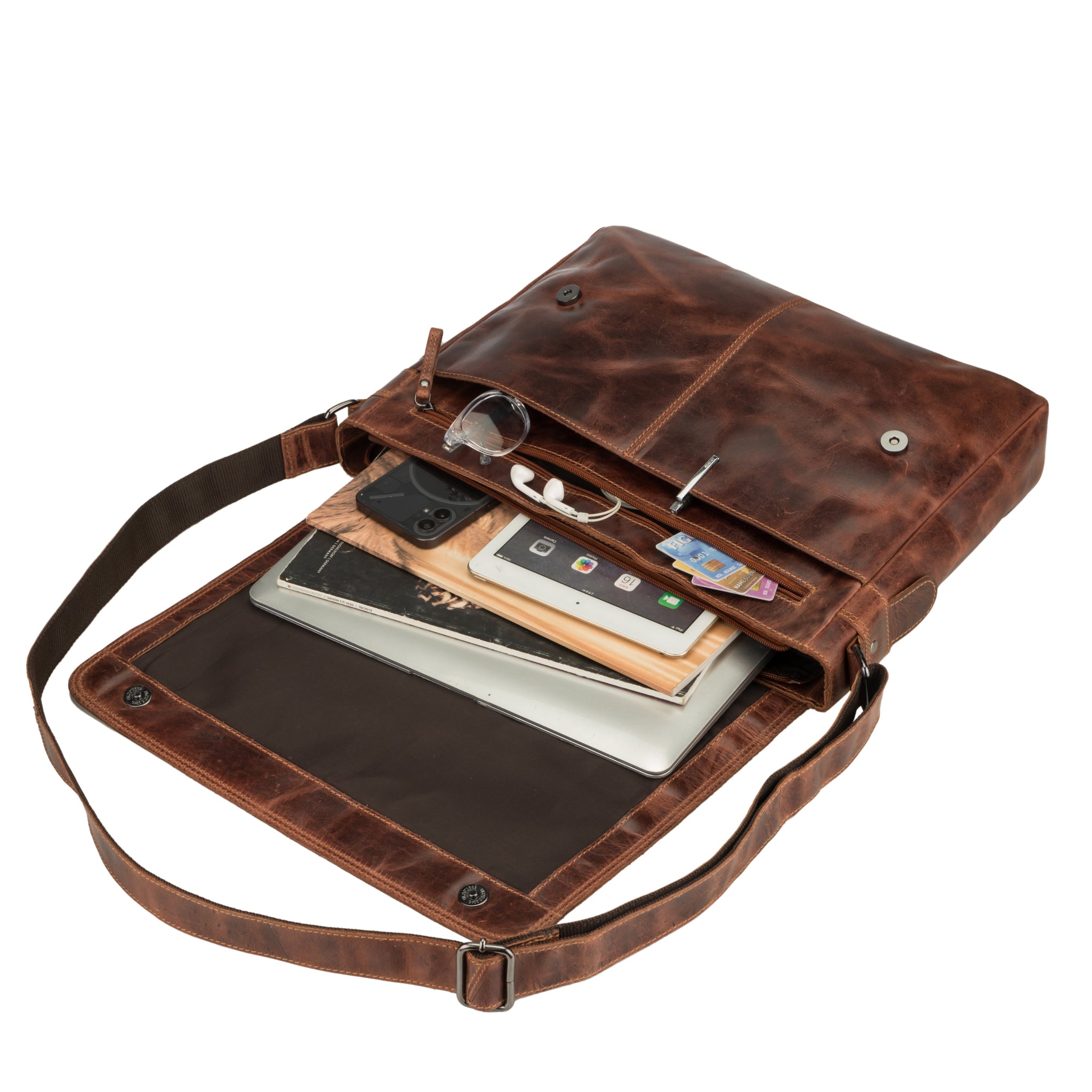 Brown Minori leather bag with compartments containing items like phone, Laptop, Books on a white background