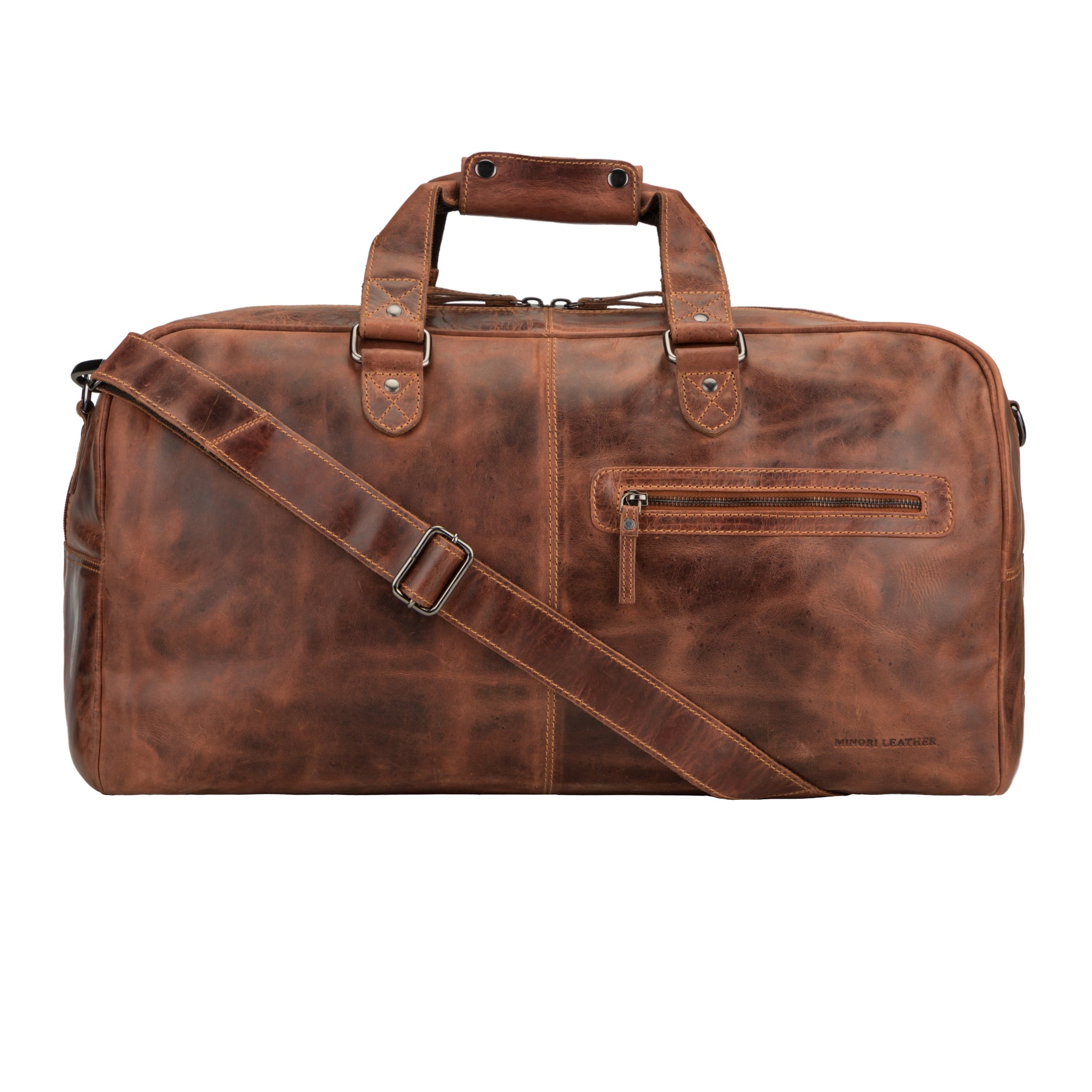 Close-up front shot of a chestnut brown Minori leather travel duffel bag with visible shoulder strap and sturdy stitched handles.