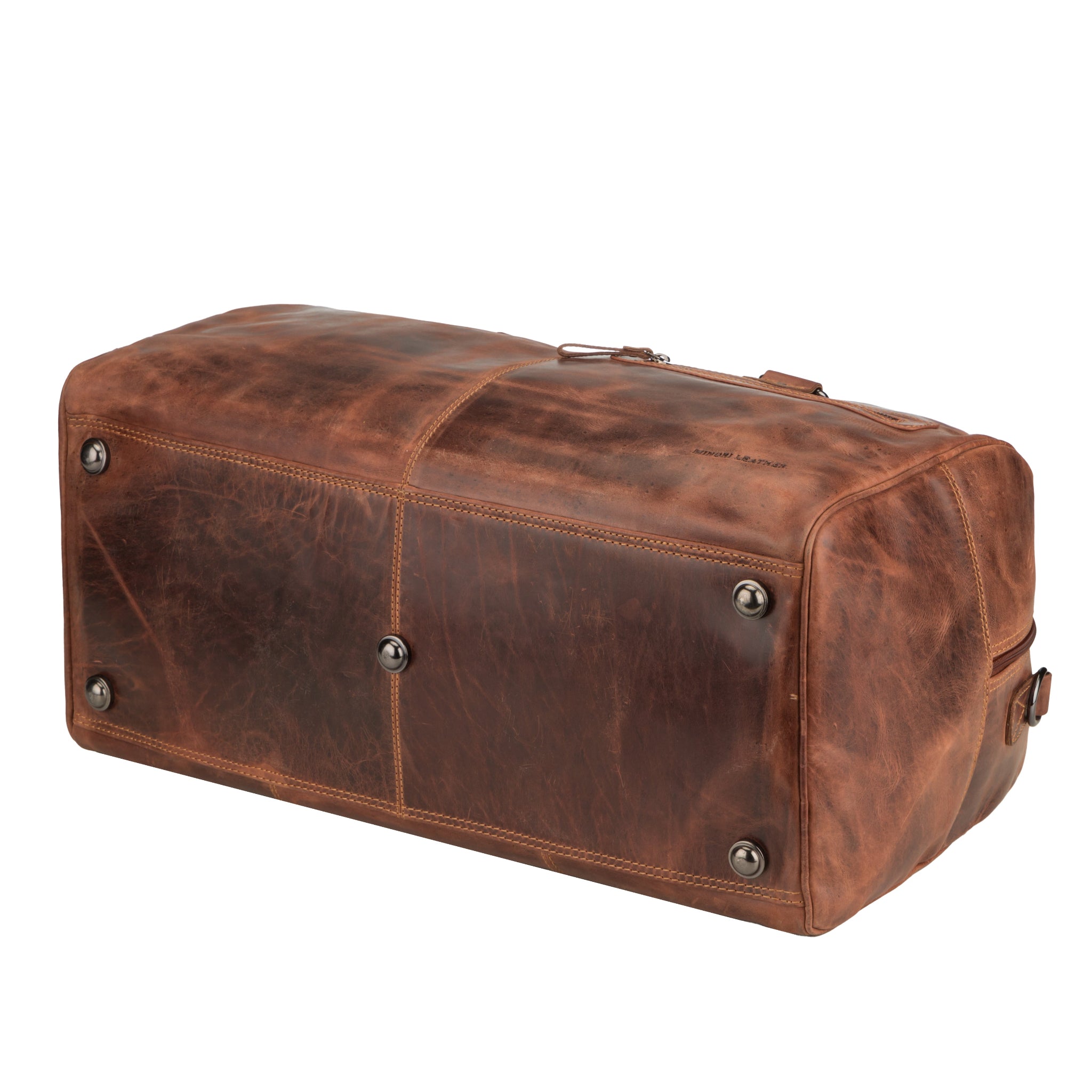 Bottom view of chestnut brown Minori leather duffel bag with four metal feet for protection and durable stitched base.