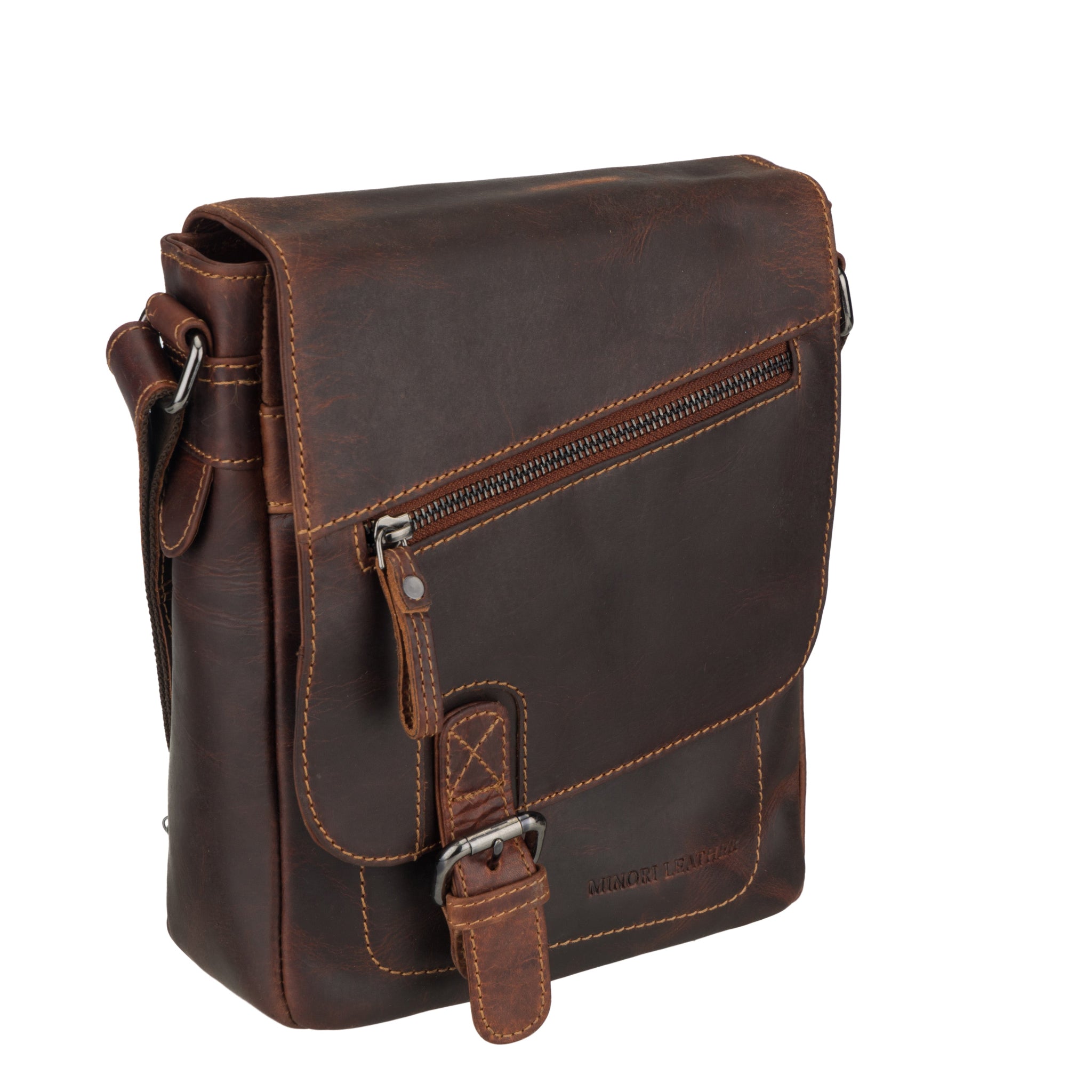 Side angle of a chestnut brown Minori leather crossbody bag highlighting front zipper and buckle.