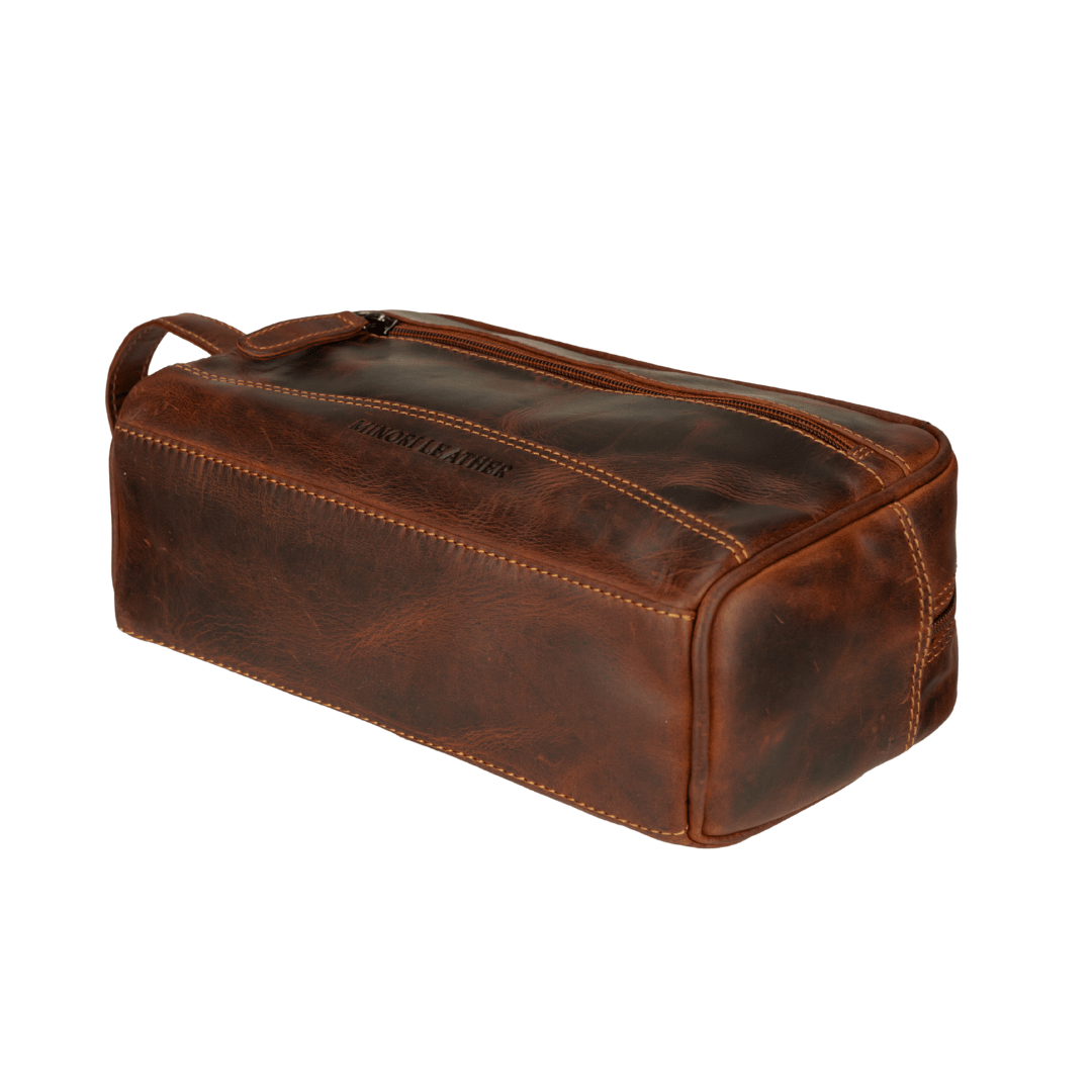 Minori Leather Montana premium leather toiletry bag for men in chestnut, featuring a sleek, durable design with zipper closure and handle.