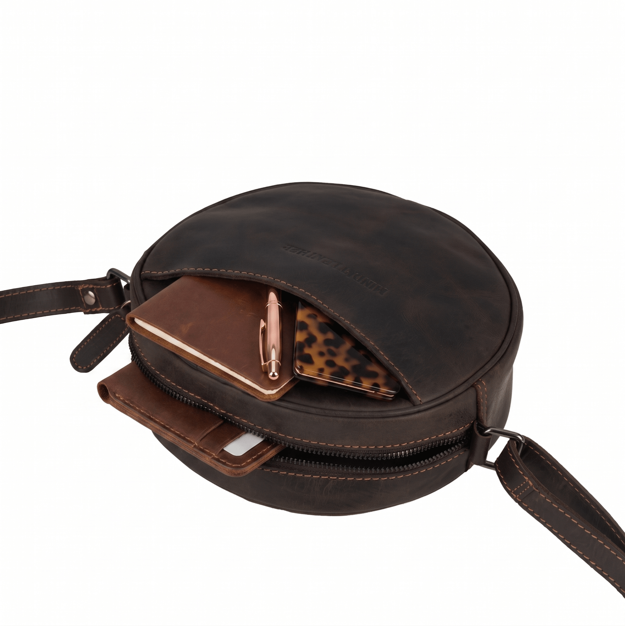 Minori Leather Luna round crossbody bag in chestnut and hair-on brown leather, stylish women's accessory with adjustable strap.