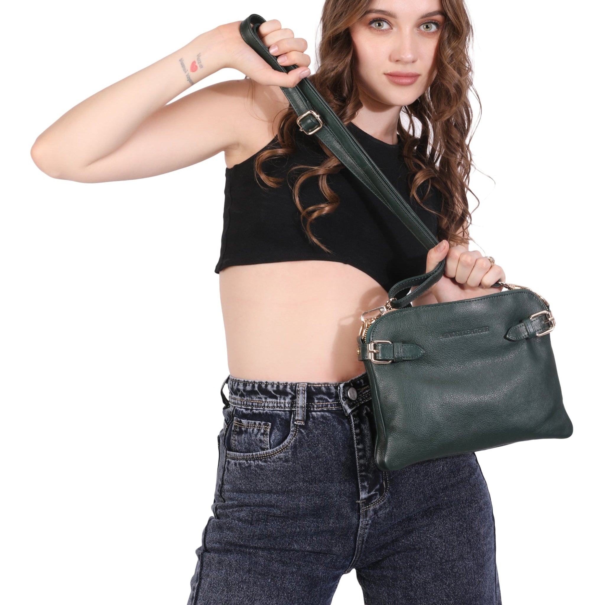 Woman holding a Forest green Minori leather handbag against a white background