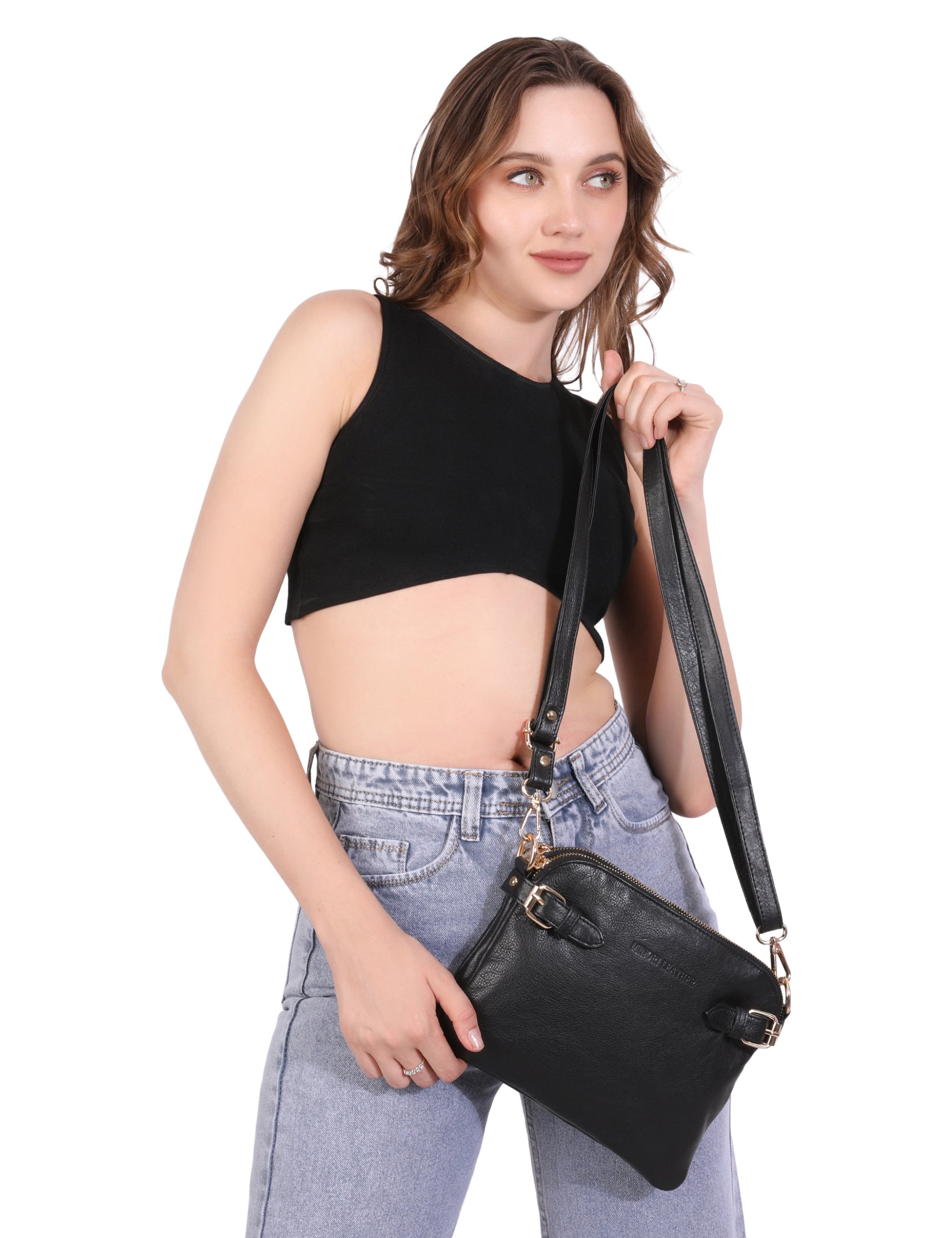 Woman holding a black Minori leather handbag against a white background