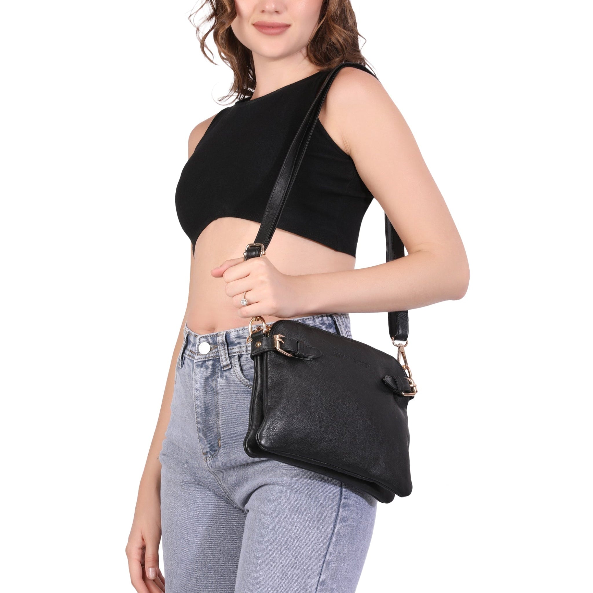 Woman holding a black Minori leather handbag against a white background