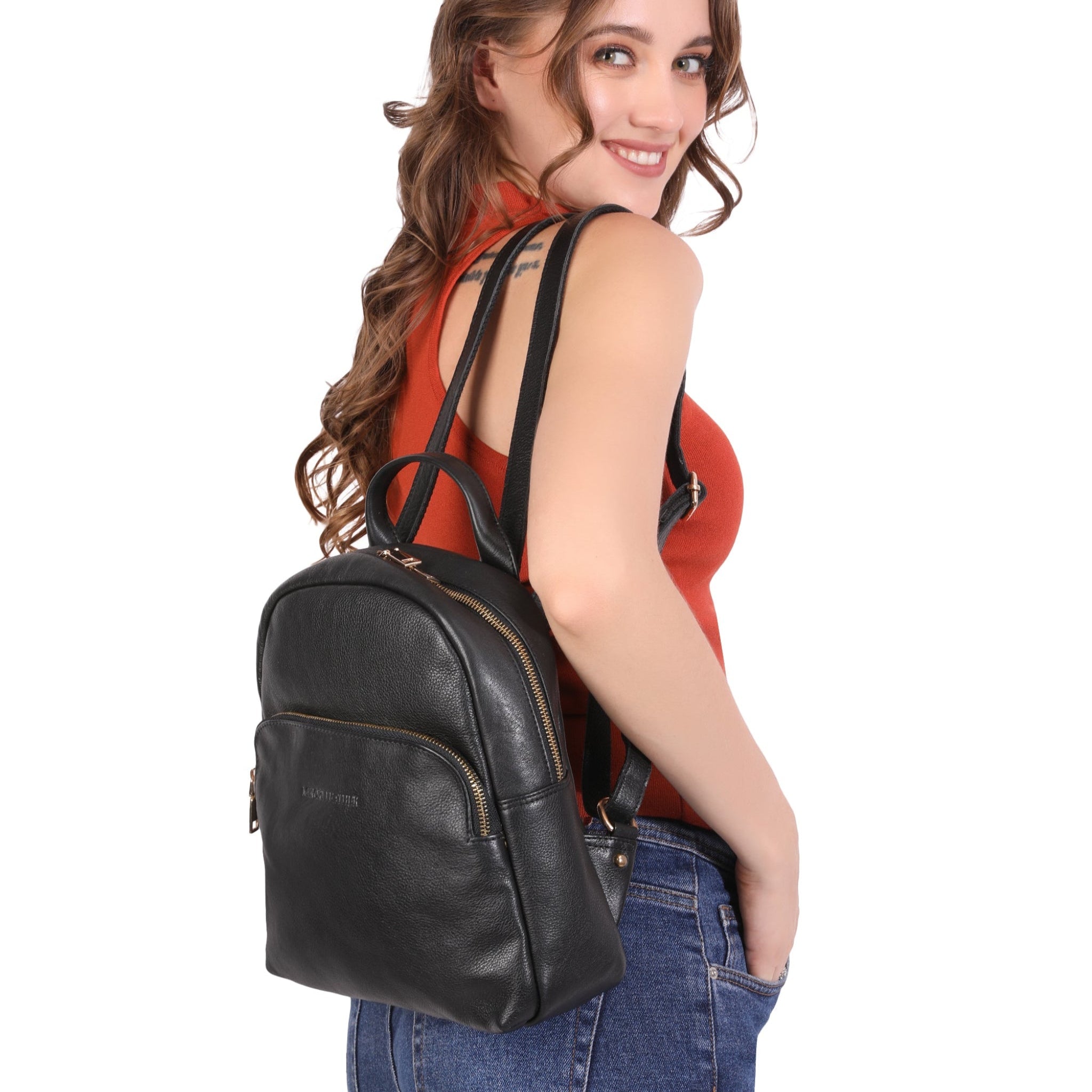 Woman wearing a black Minori leather backpack on a white background