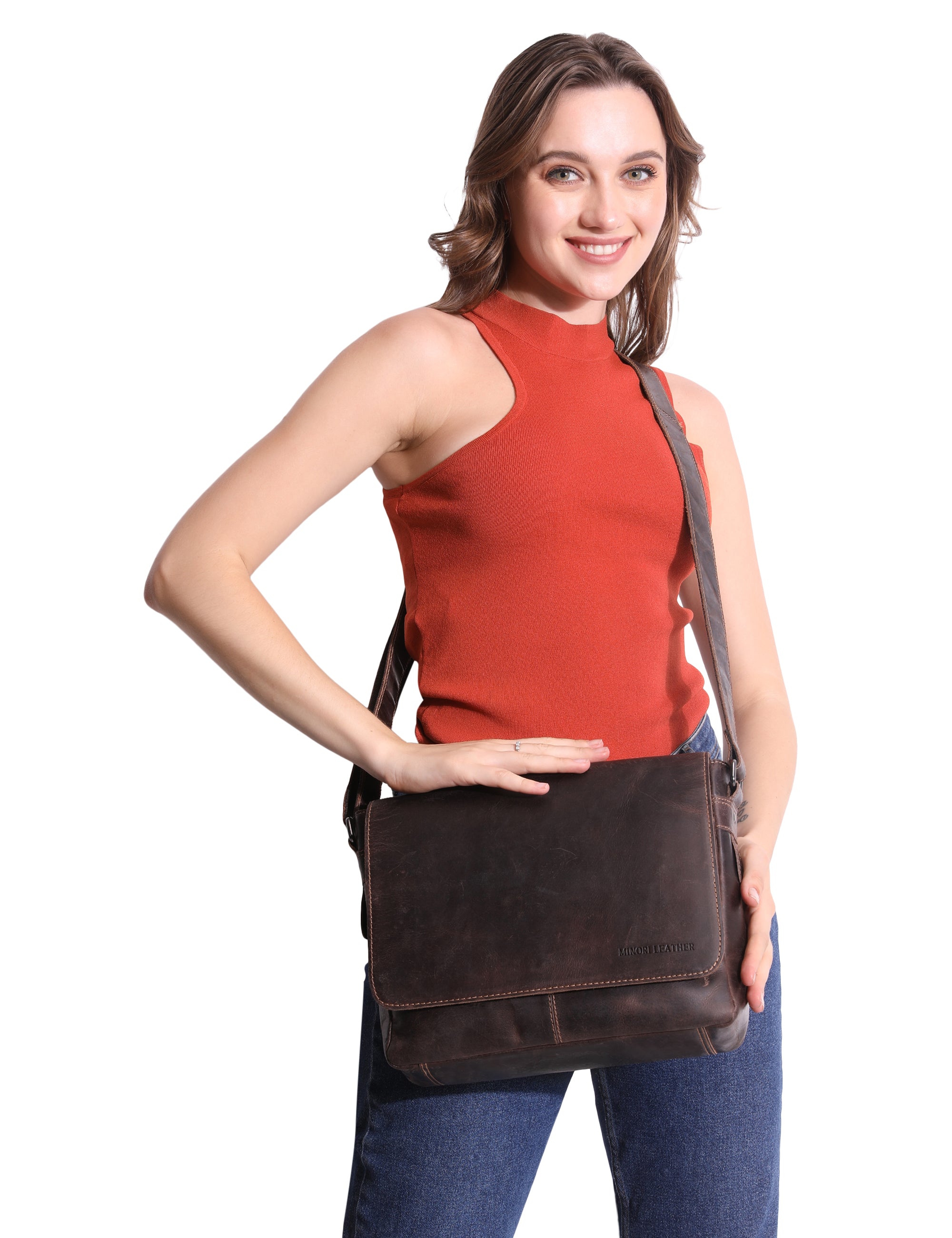 Woman holding a brown leather bag against a white background