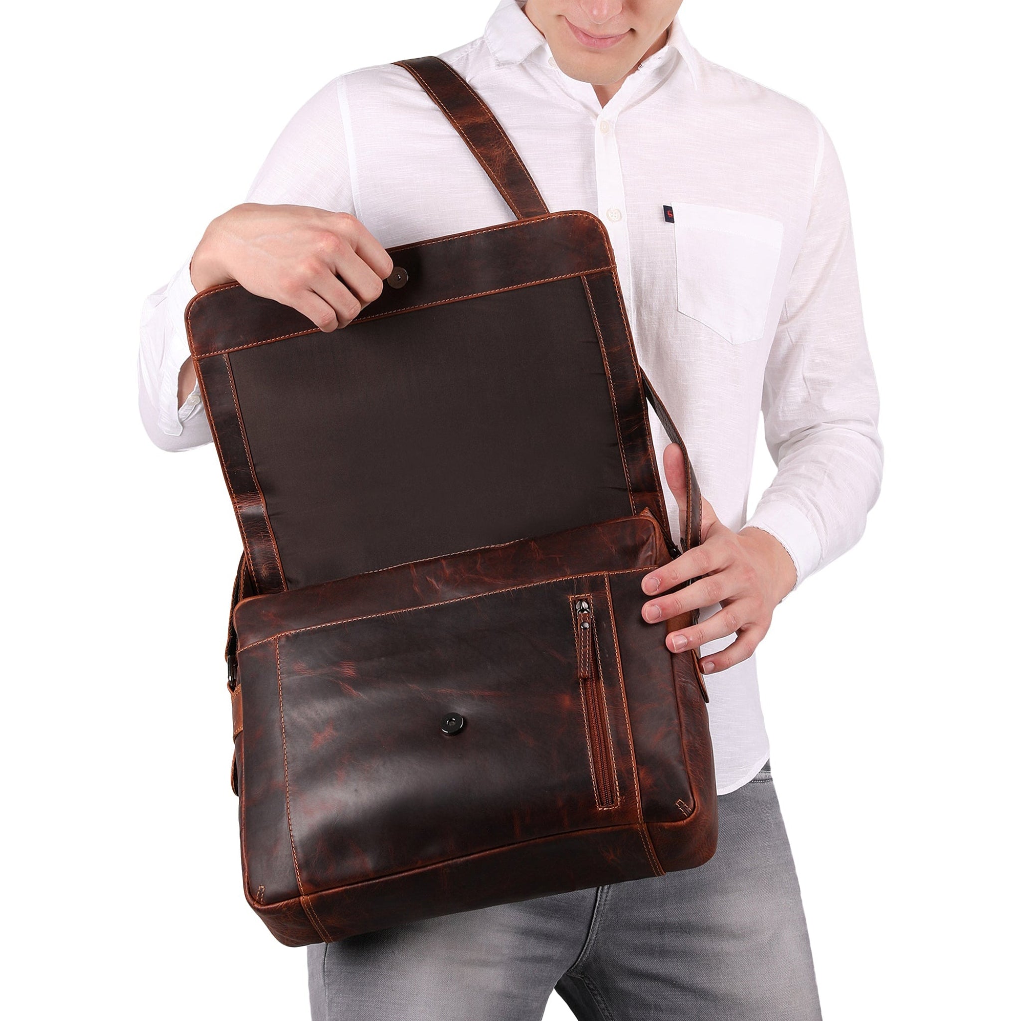 Person holding a brown Minori leather bag against a white background