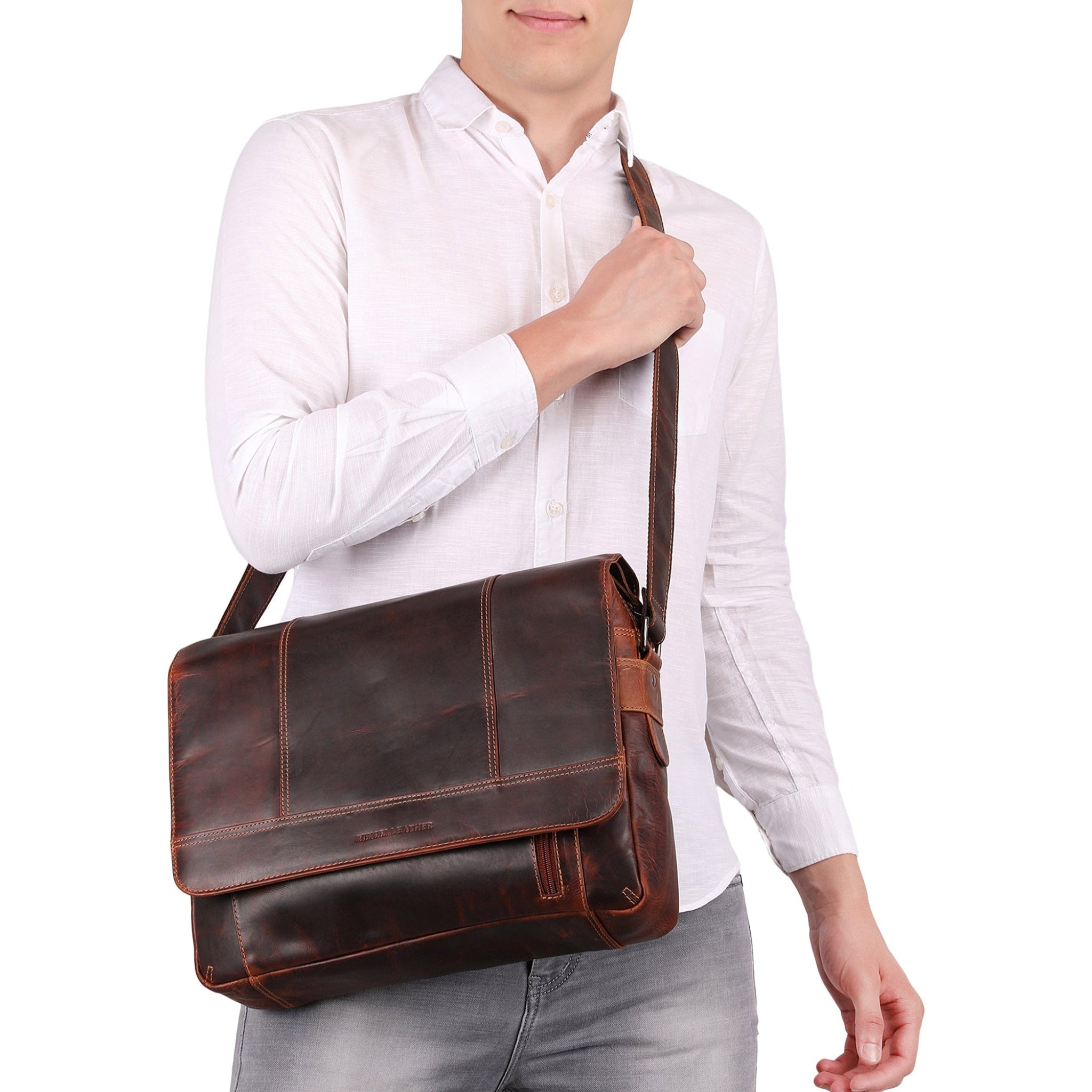 Man holding a brown Minori leather bag against a white background