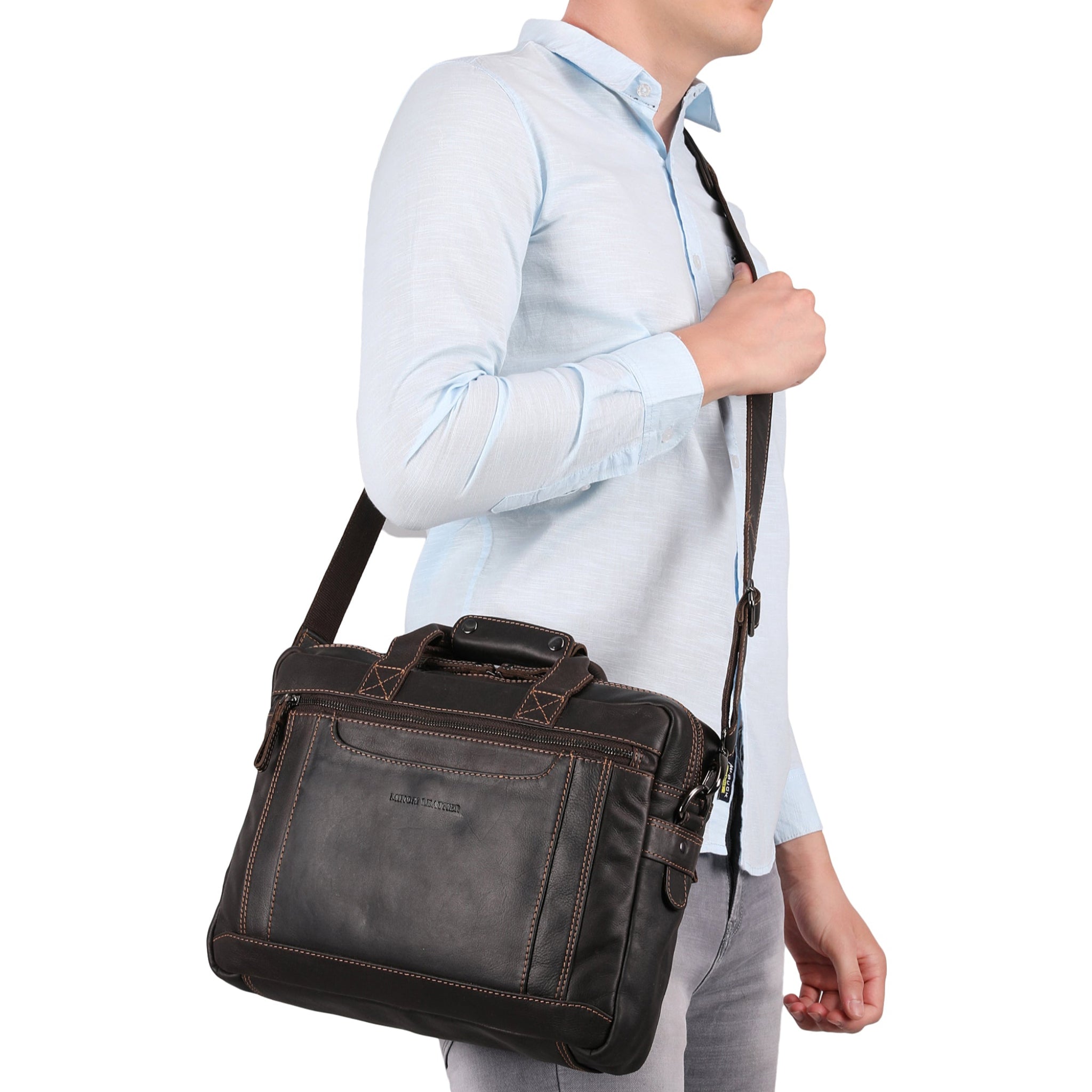 Man holding a dark brown Minori leather briefcase against a white background
