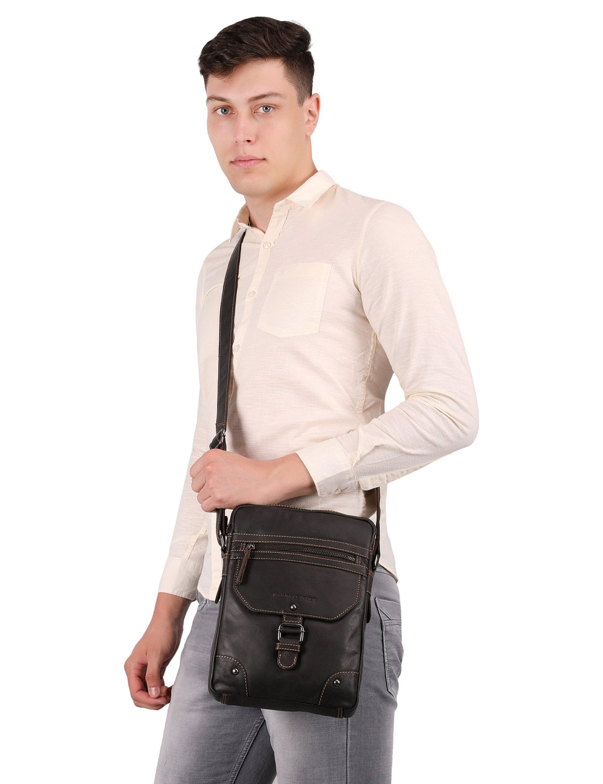 Minori Leather Denver Crossbody Bag in chestnut leather, unisex design with adjustable strap and front pocket detail.