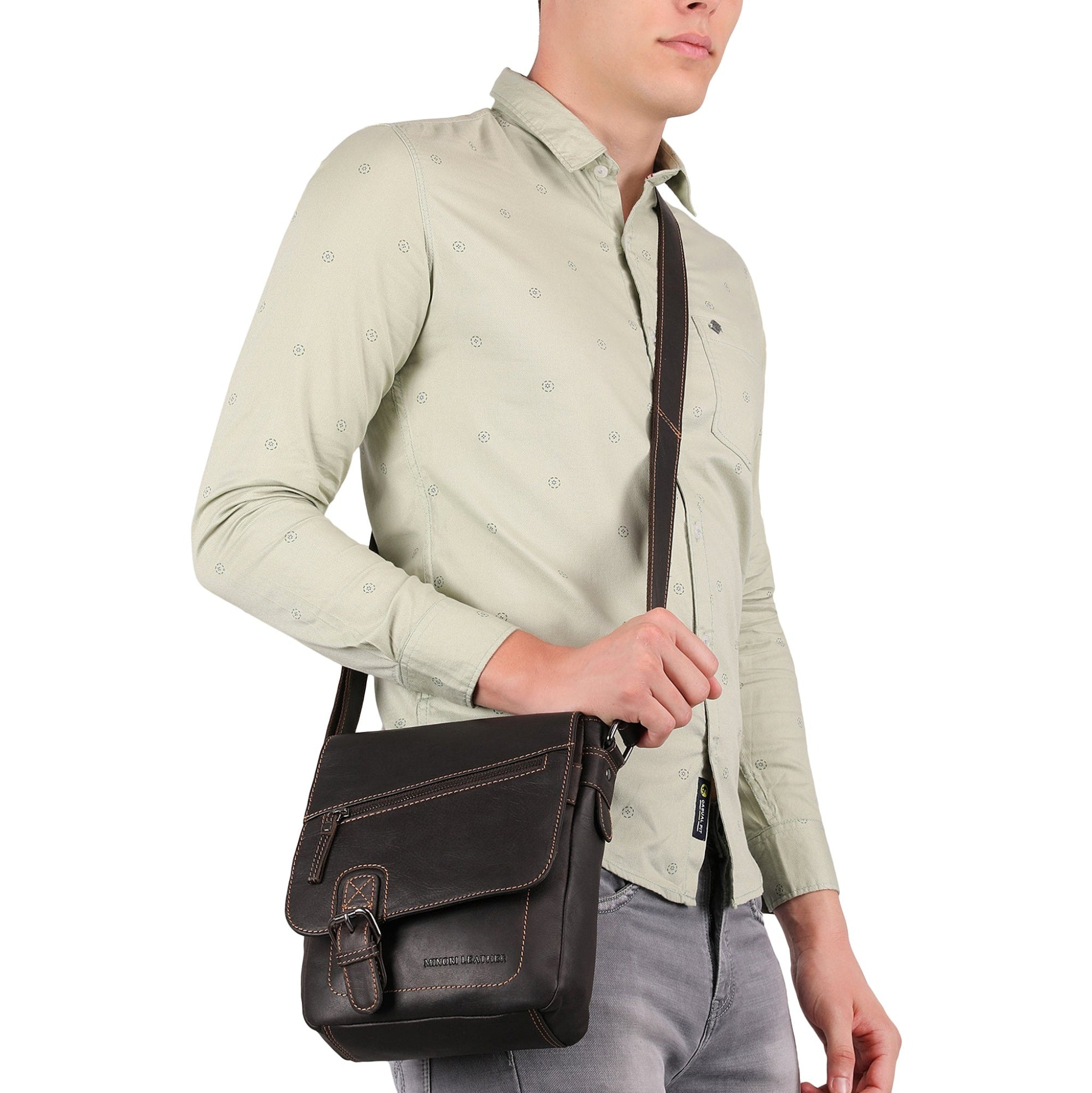 Side view of a man carrying a brown Minori leather crossbody bag across the shoulder.