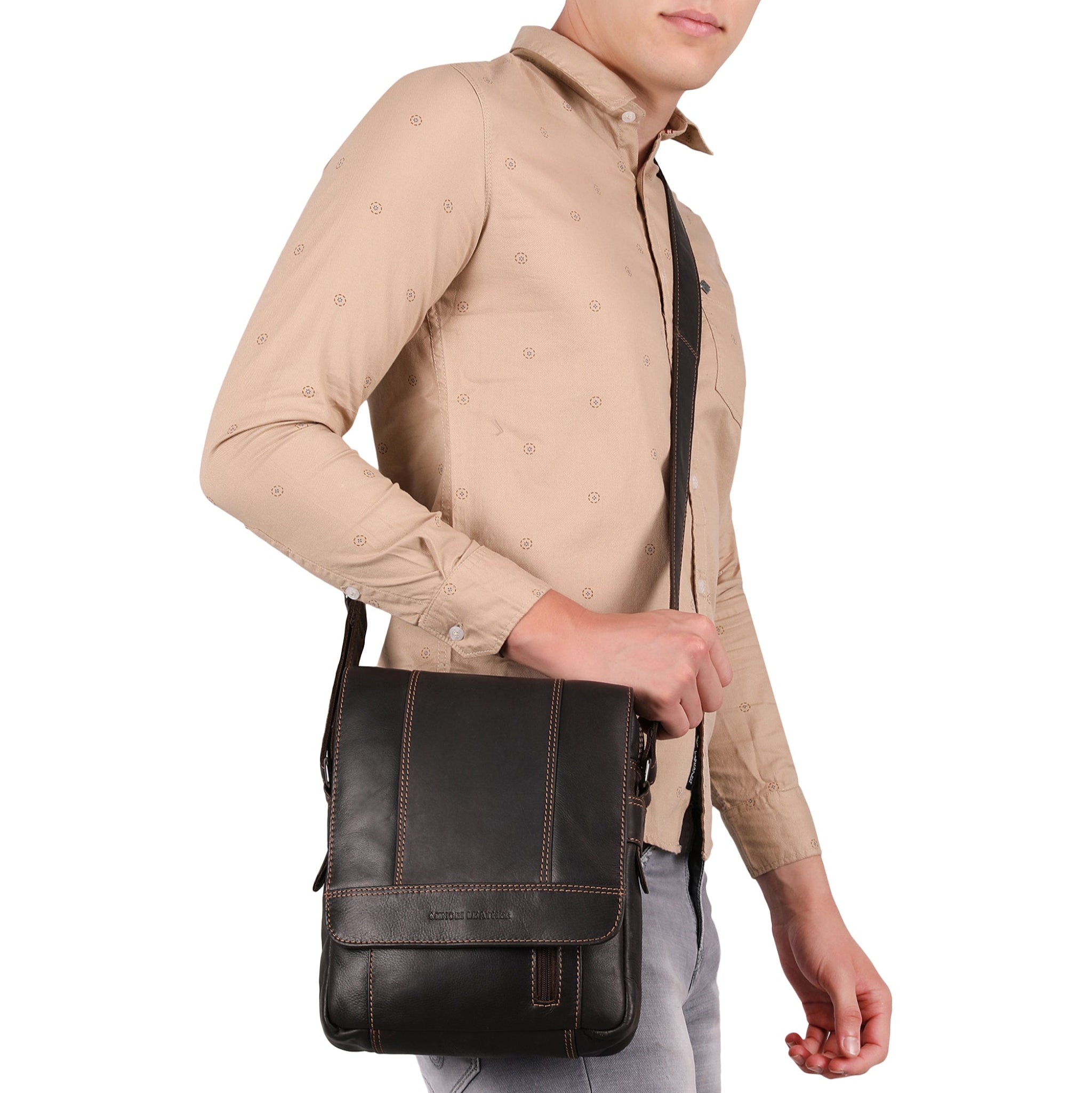 Man holding a Brown Minori leather bag against a white background