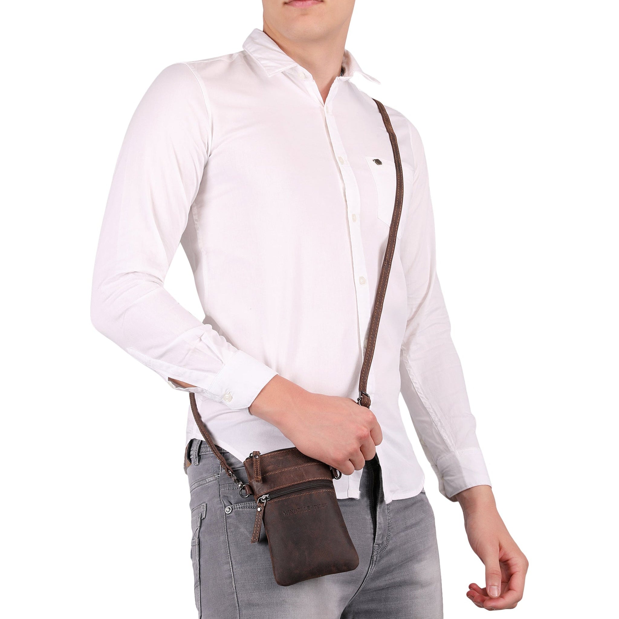 side Man posing with a brown Minori leather crossbody bag hanging from his shoulder against a white background.