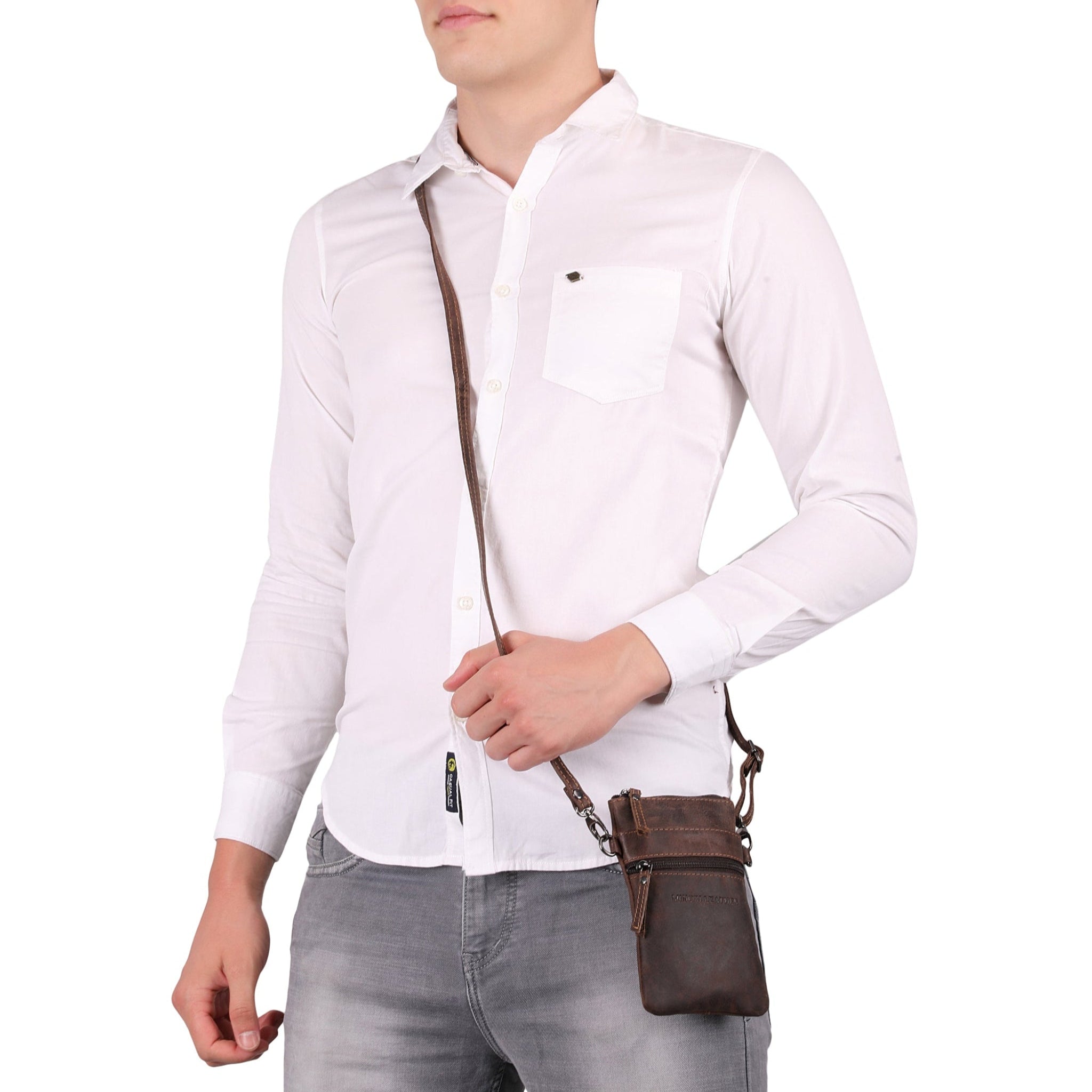 Man posing with a brown Minori leather crossbody bag hanging from his shoulder against a white background.