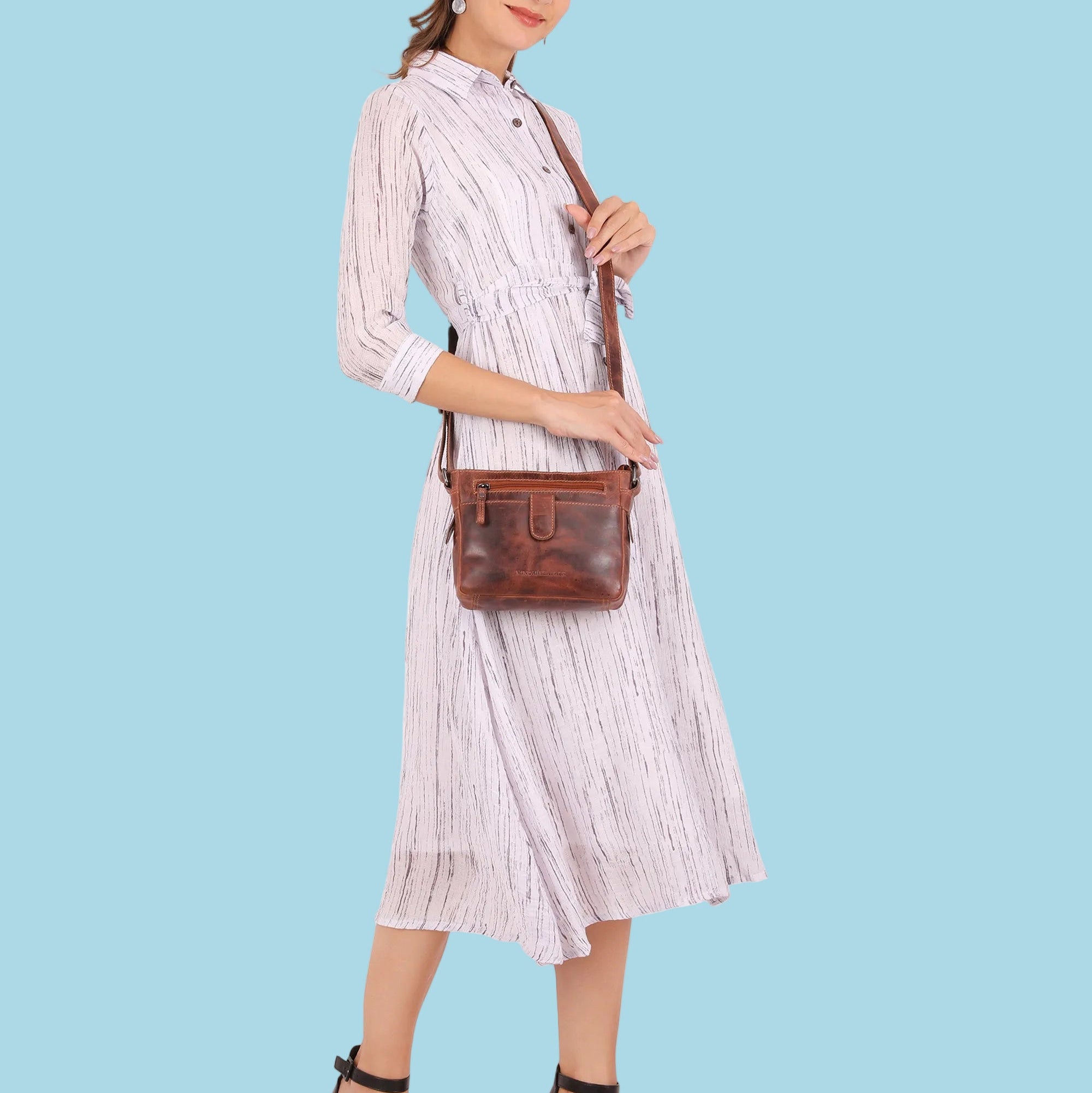 Minori Leather chestnut crossbody bag made of genuine leather, unisex design with adjustable strap and compact storage.