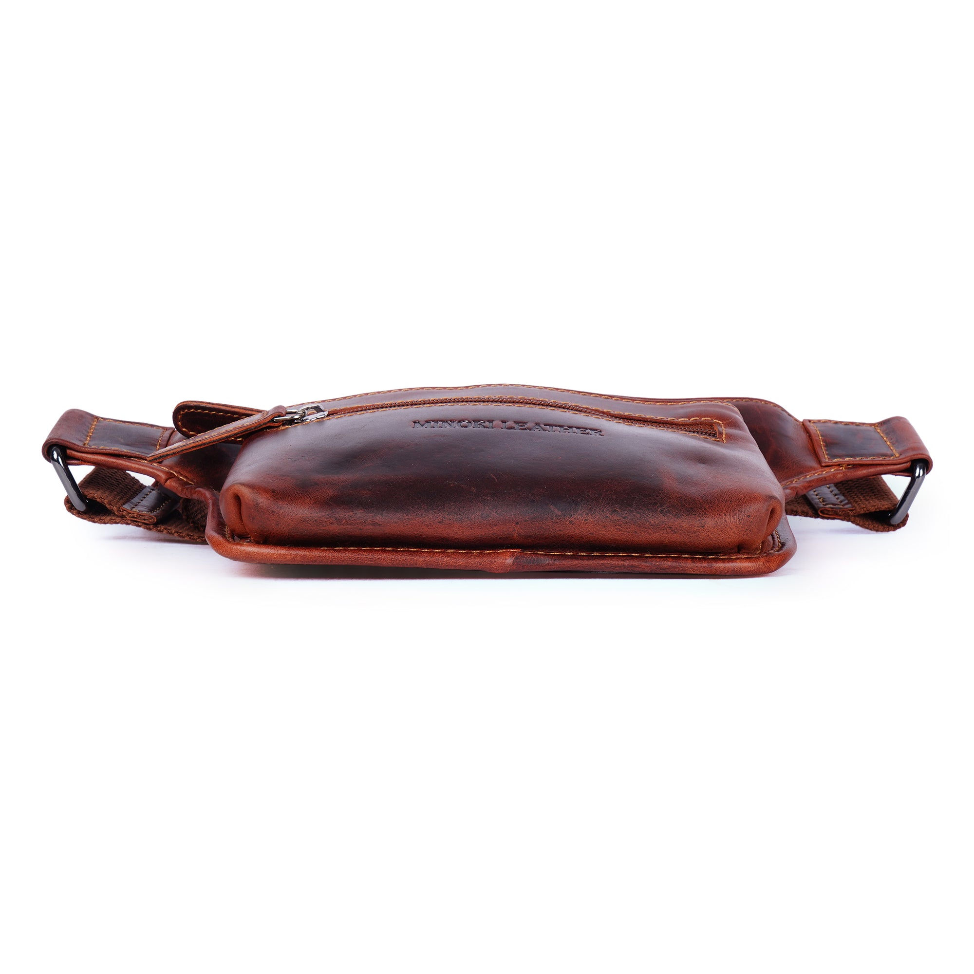 Unisex Osaka Leather Belt Bag in chestnut color with adjustable strap and Minori Leather branding, worn as a stylish fanny pack.