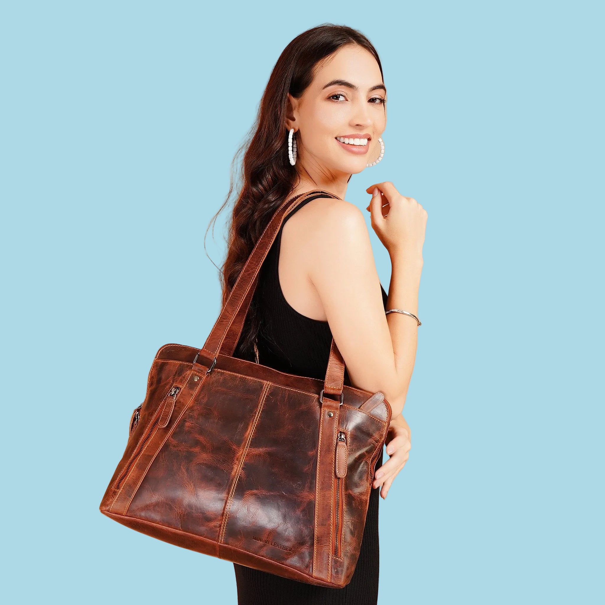 Minori Leather Camille leather laptop tote bag with sturdy handles and spacious interior, perfect for carrying laptops and essentials.