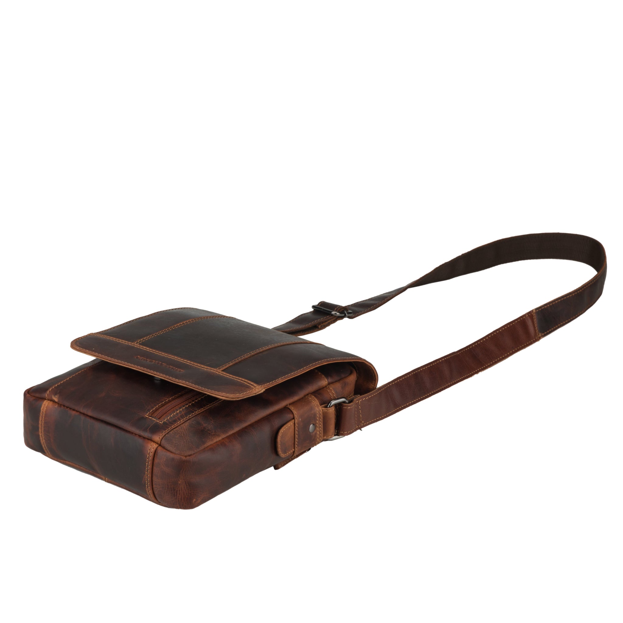 Flat lay view of Brown Minori leather bag with a strap on a white background