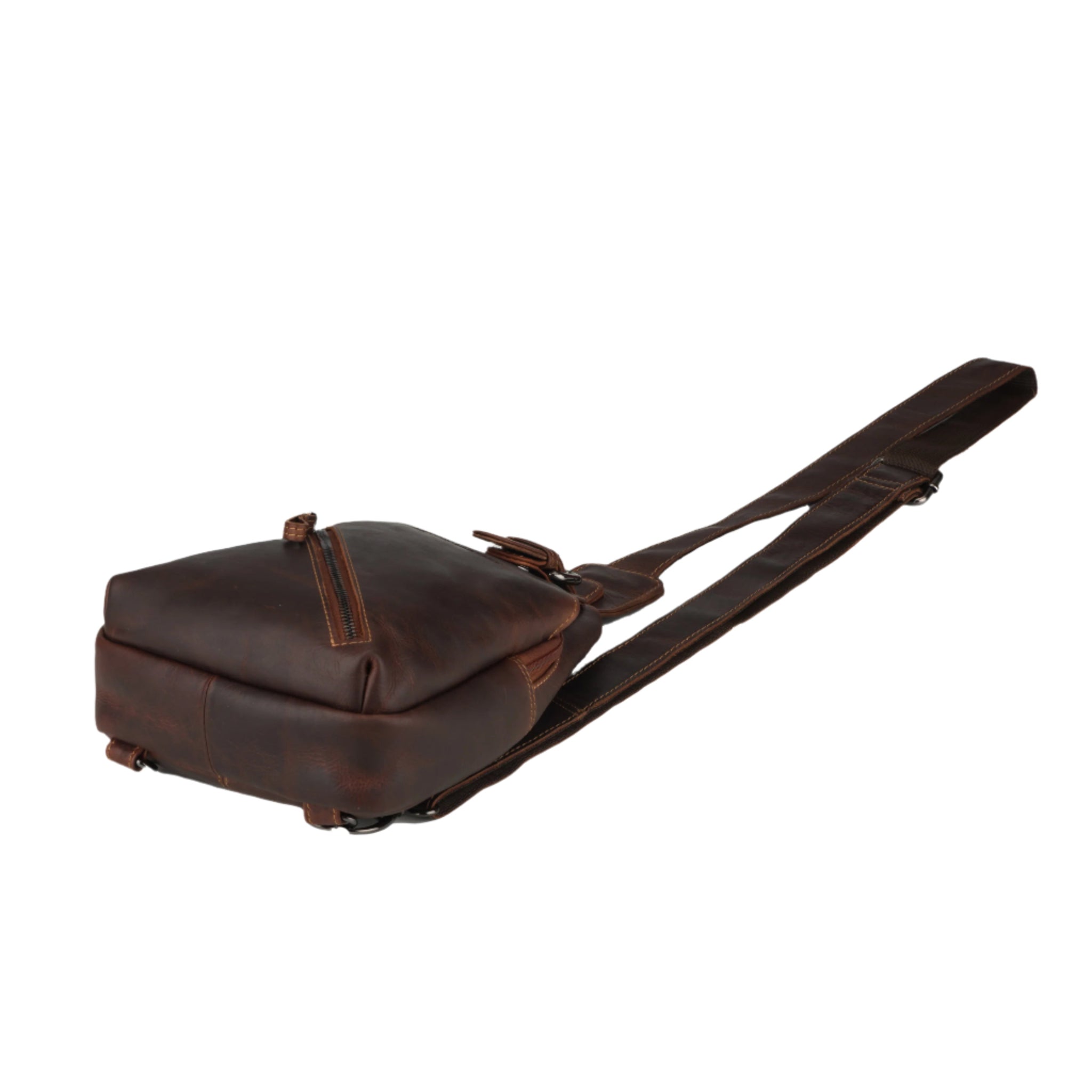 Bottom angled view of a chestnut brown Minori leather sling bag showing base and strap position.