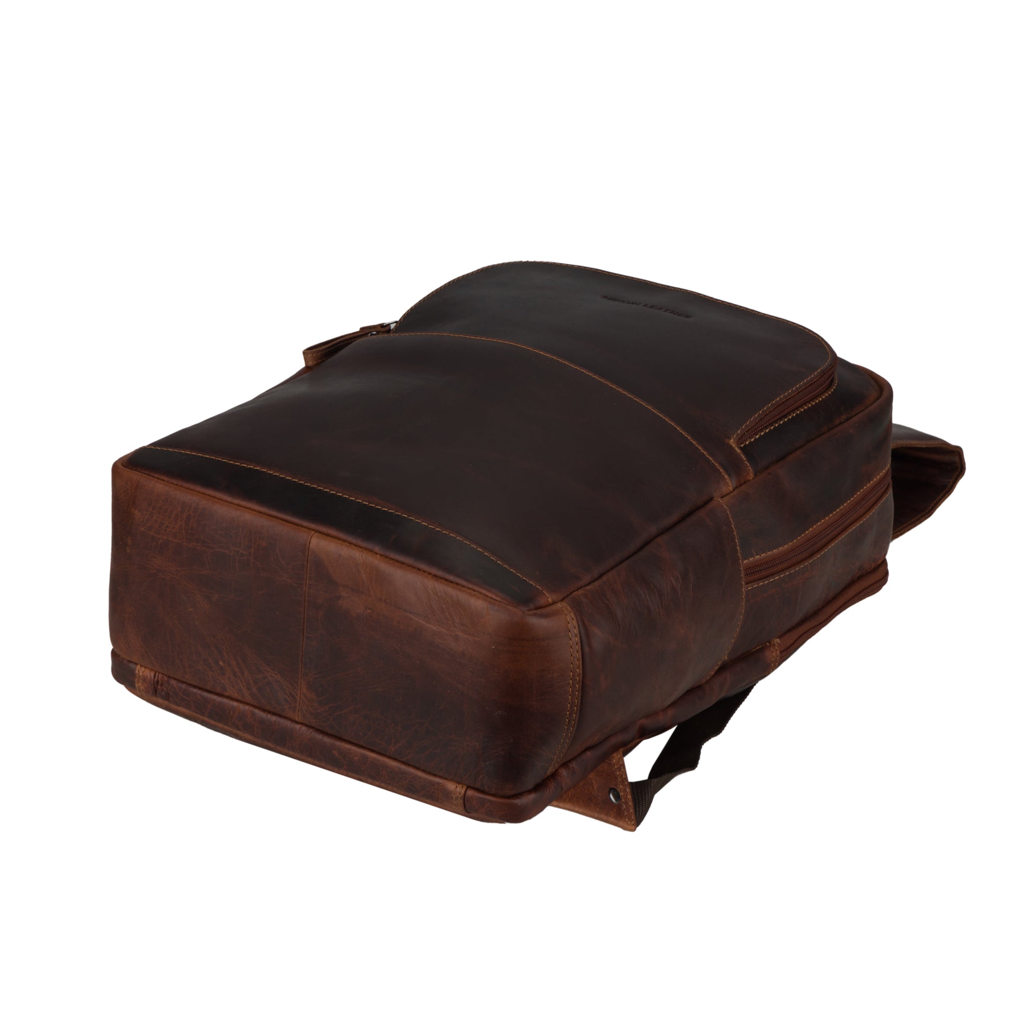 Bottom view of a chestnut brown Minori leather backpack showing the sturdy leather base and structure.
