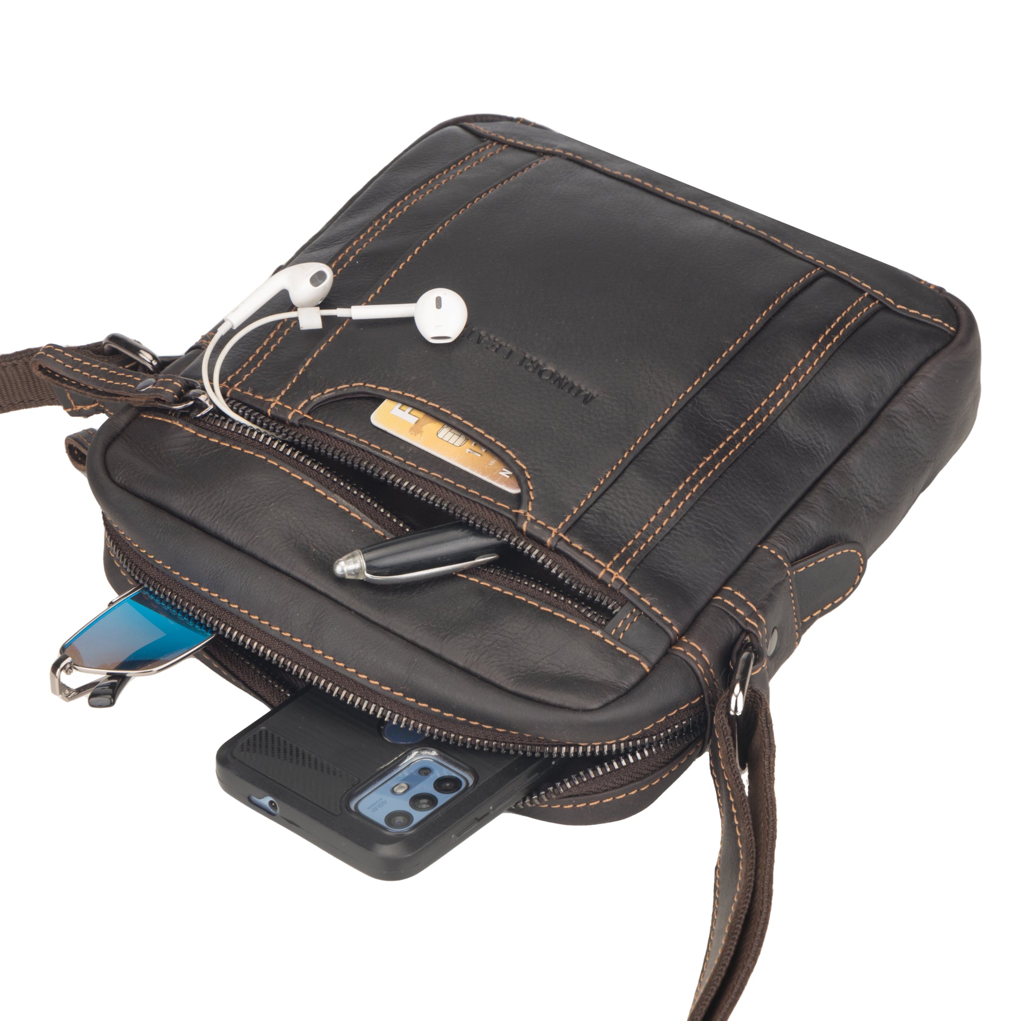 Brown Minori leather bag with phone, pen, and earbuds on a white background