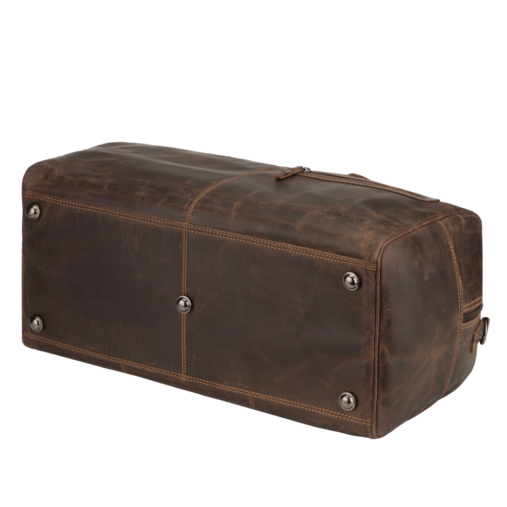 Bottom view of a brown Minori leather duffle bag showing metal feet for protection and reinforced stitching.