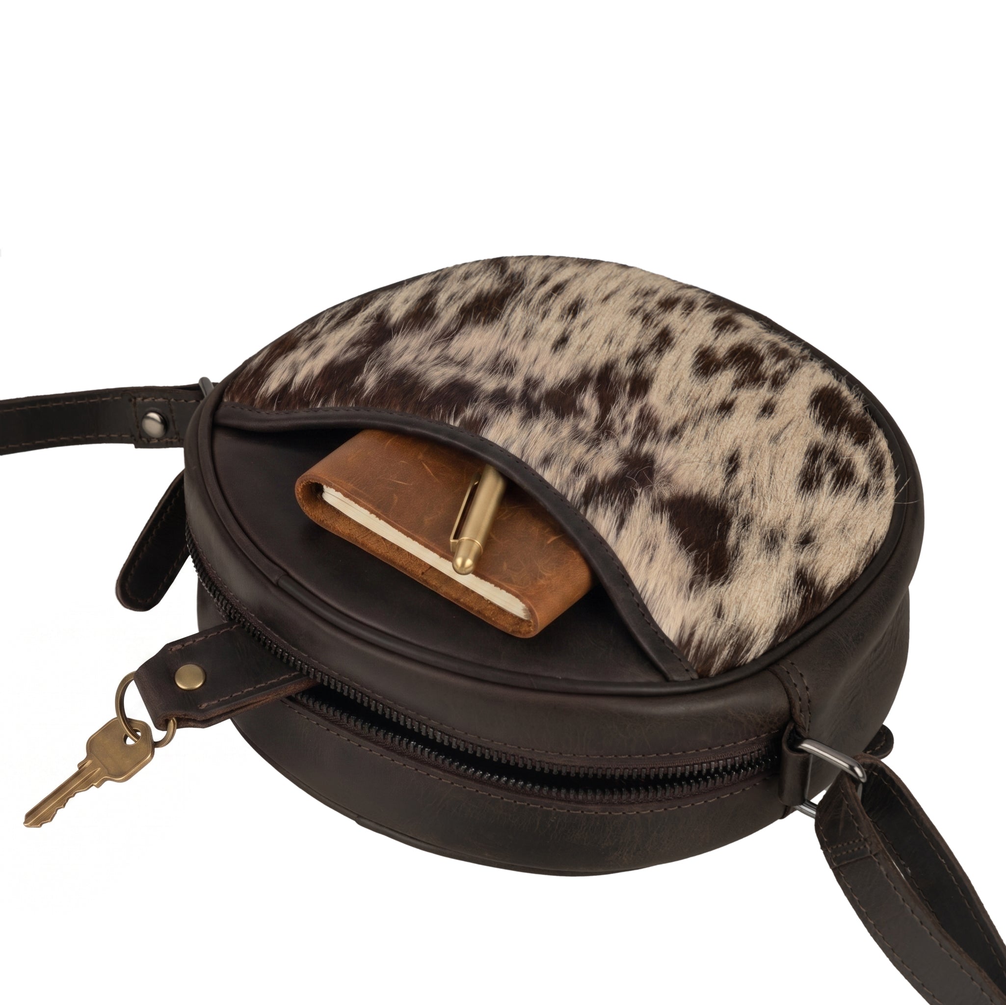 Minori Leather Luna leather round crossbody bag in chestnut, brown, and hair-on brown with adjustable strap and stylish design.