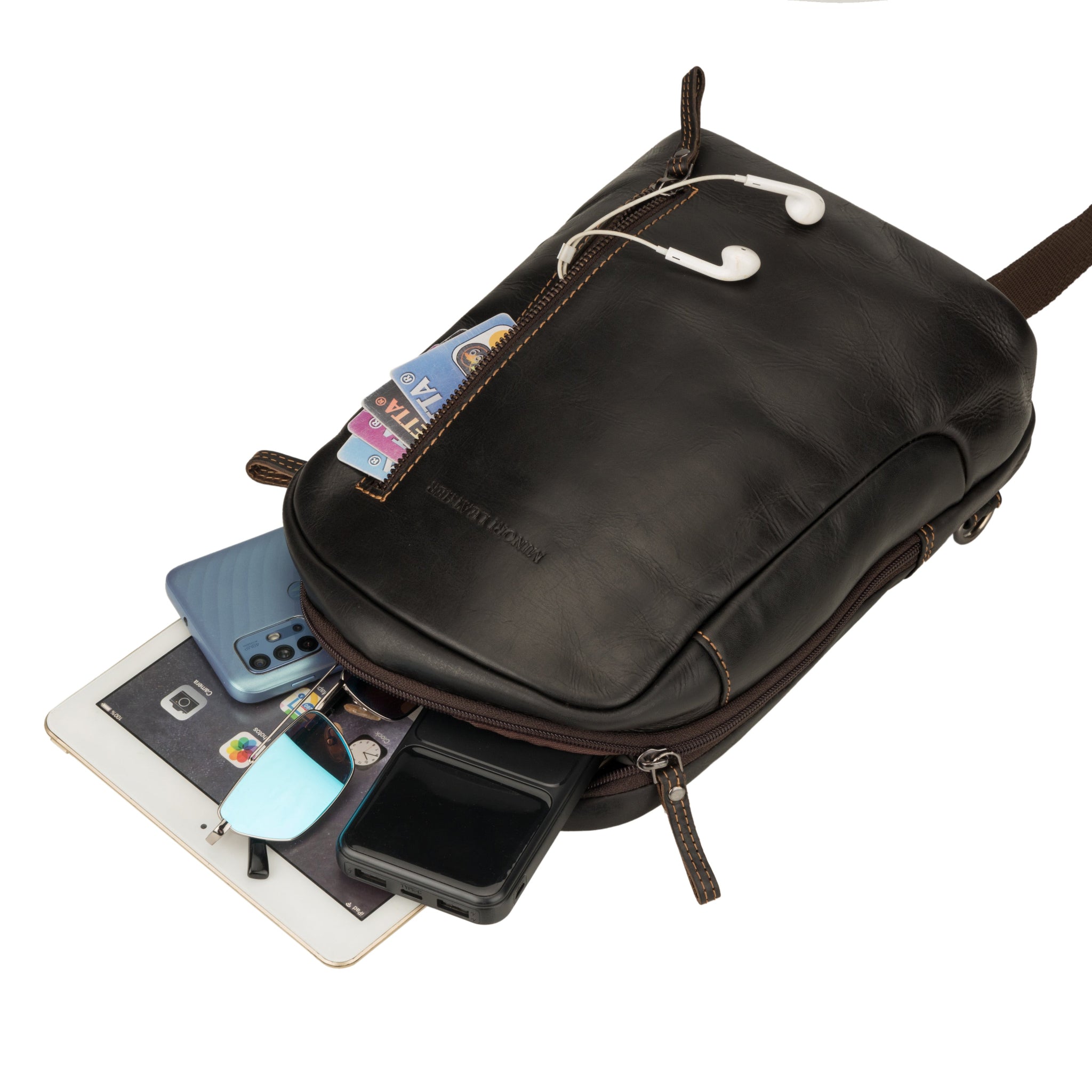 Brown Minori leather crossbody sling bag with its compartments open, displaying cards, gadgets, and accessories.