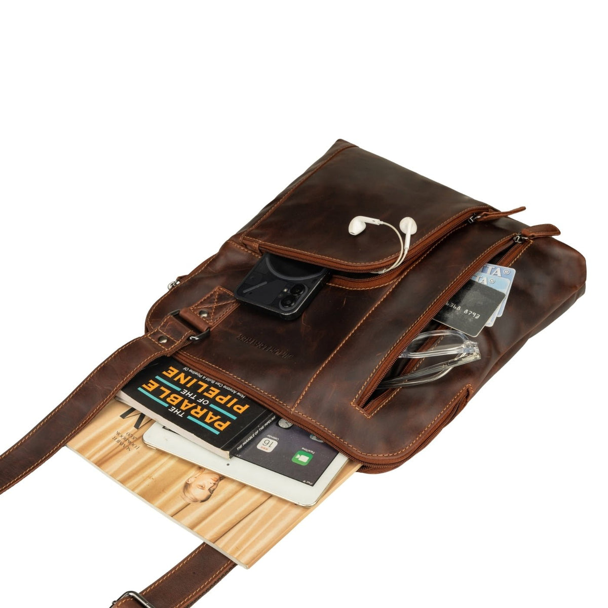 Minori Leather Ryder unisex shoulder bag in chestnut leather, featuring a sleek design and adjustable strap for everyday use.