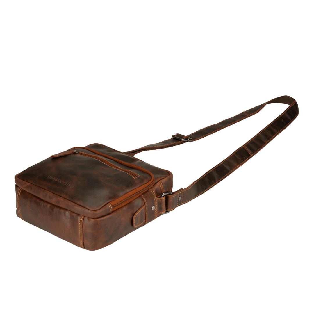 Minori Leather Harbor leather crossbody bag in chestnut with adjustable strap and minimalist design, featuring smooth leather surface.